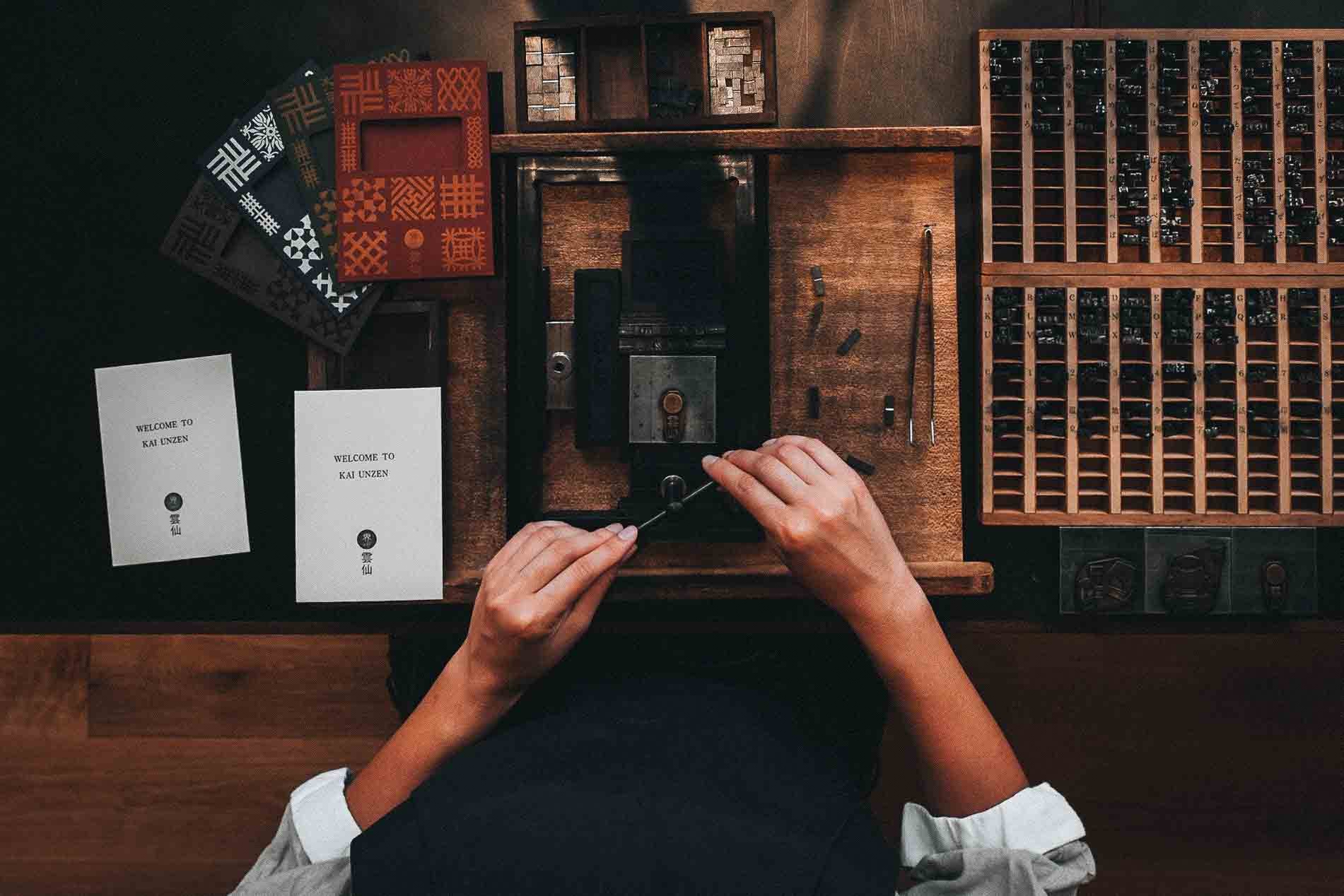 An employee at KAI Unzen makes welcome cards using the hotel’s historic Dutch letterpress, a symbol of cultural exchange in Nagasaki.
