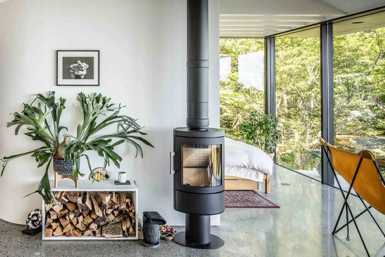  A wood-burning stove anchors the living area, supplementing the home’s under-floor heating and adding warmth to the concrete interior. 