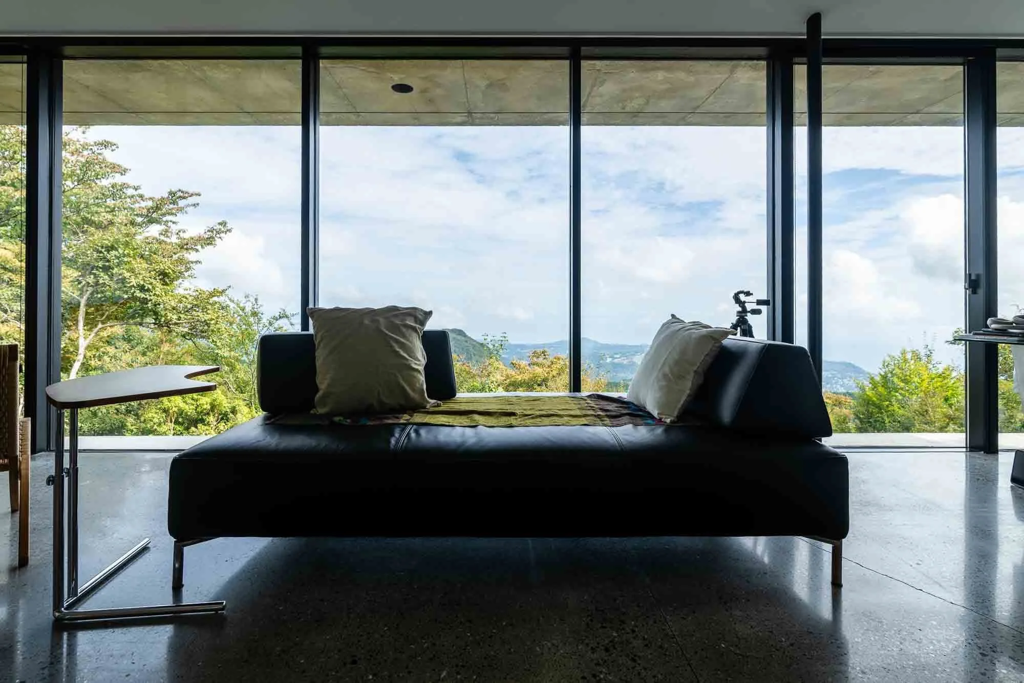  Interior of the engawa-inspired home showing its eastern-facing wall of glass and minimalist design. 