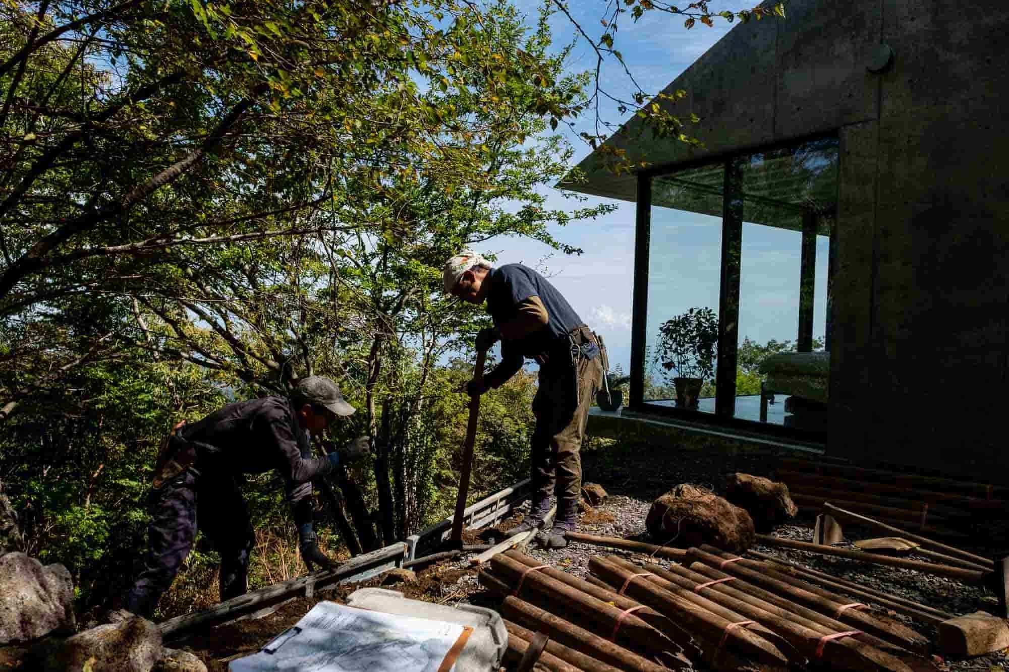  Local landscapers building a retaining wall on the property. The house sits on a 30-degree slope. 