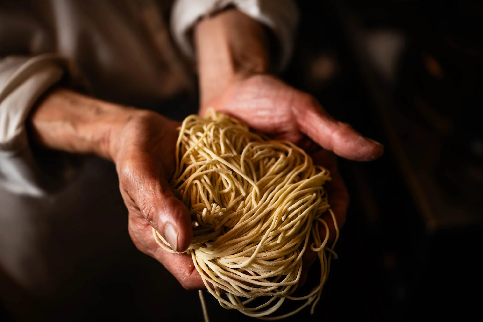  Chef Matsura holding a handful of ramen in his restaurant in Ginza, Tokyo. 