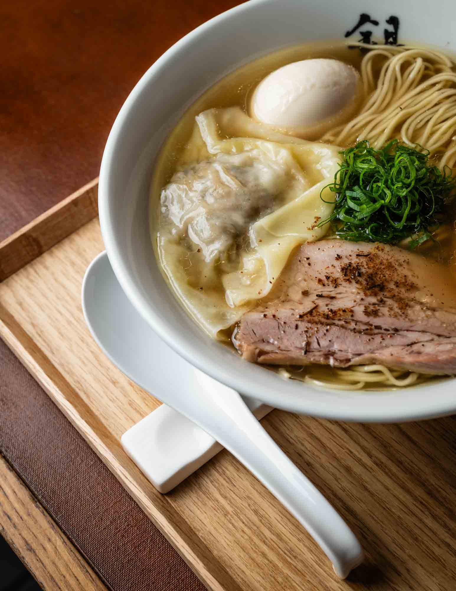  Ginza Hachigou’s most popular dish, Gourmand Ravioli Ramen. The ramen is topped with delicate wontons filled with truffle and foie gras. Japan food photography by Ben Weller. 