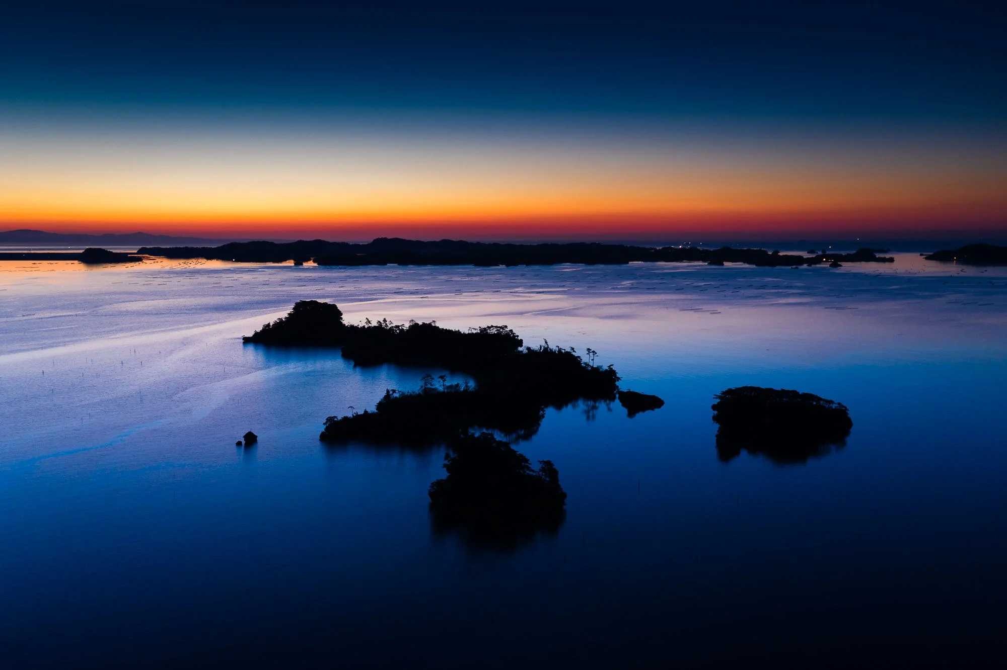A serene sunset over islets in Matsushima Bay, photographed by Japan travel photographer Ben Weller.