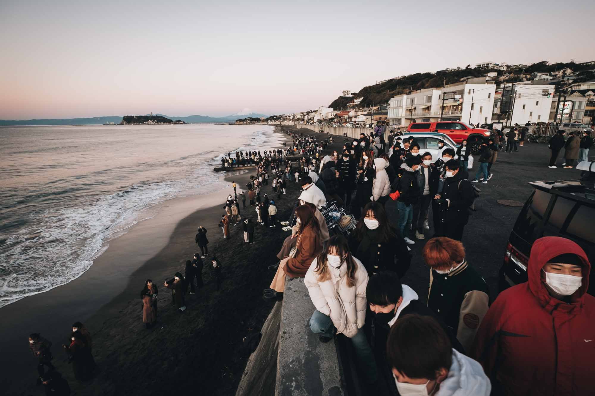 People watch hatsuhinode at Shichirigahama Beach in Kamakura.