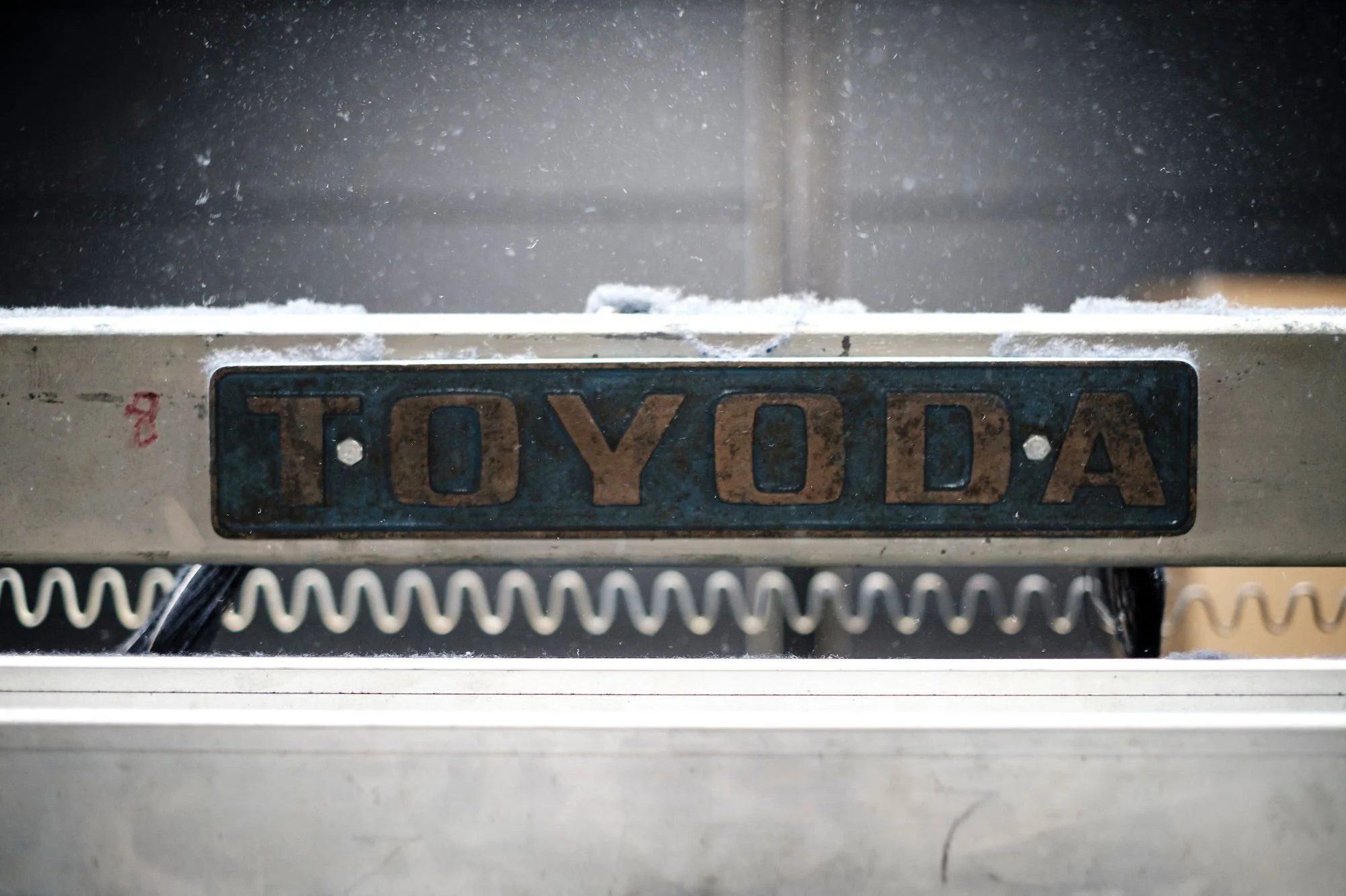 Close-up of a vintage Toyota weaving loom inside a denim production facility in Kojima, Japan photographed by editorial photographer Ben Weller.