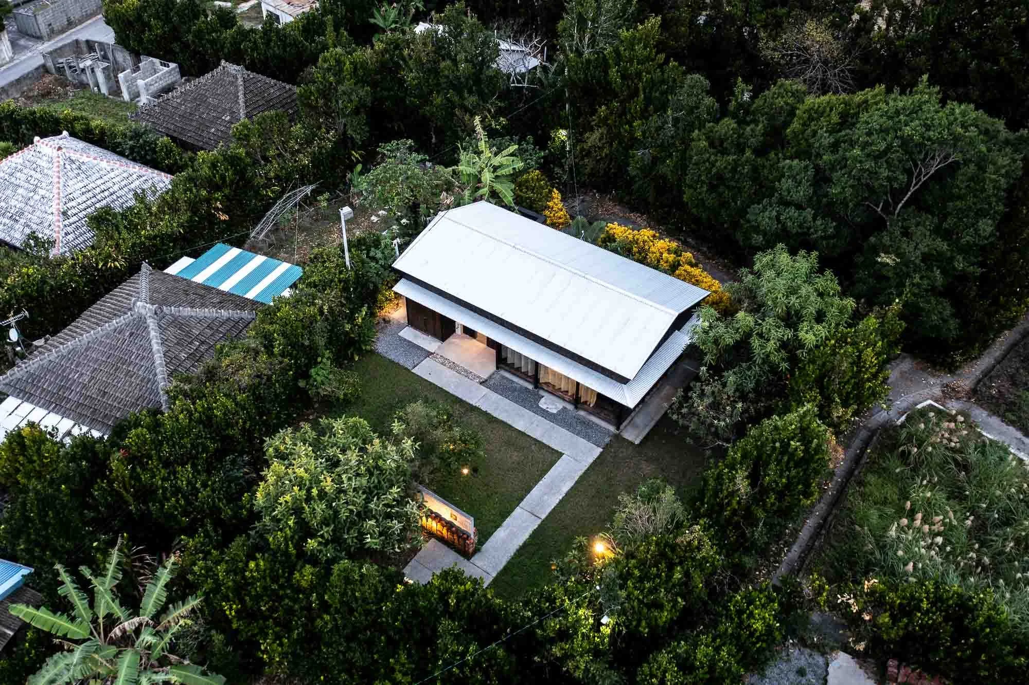 Aerial view of a traditional kominka home in Okinawa that has been converted into a boutique bed and breakfast, photographed by Japan hotel photographer Ben Weller.