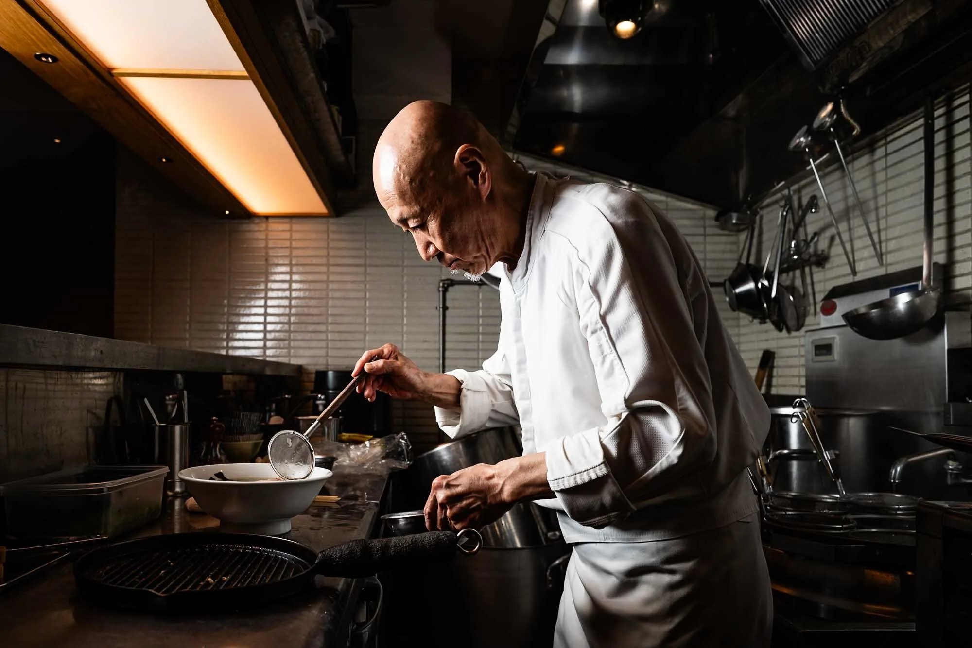 Yasushi Matsumura of Ginza Hachigou prepares the restaurants most popular dish, Gourmand Ravioli Ramen. The ramen is topped with delicate wontons filled with truffle and foie gras.