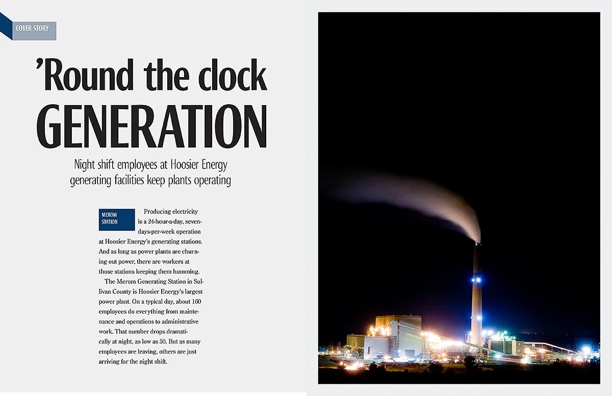 Nighttime photo of a large power plant with a tall smokestack emitting smoke, surrounded by bright lights.