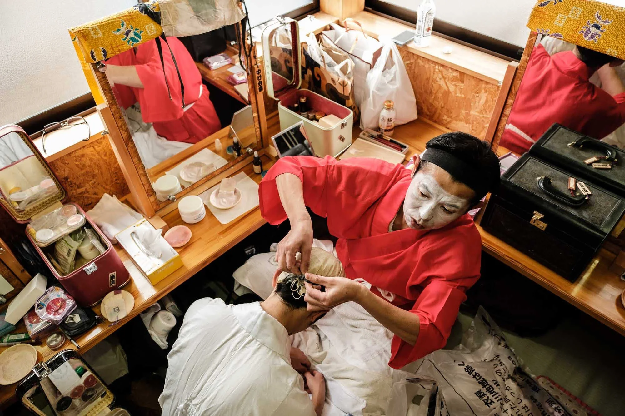 Japanese kabuki actors preparing for a performance in a backstage dressing room, photographed on assignment by Japan travel photographer Ben Weller.