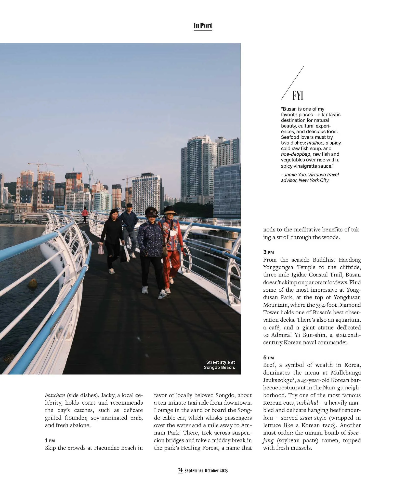 People walking on a pedestrian bridge over a river with city skyline in the background, likely in Busan, South Korea.