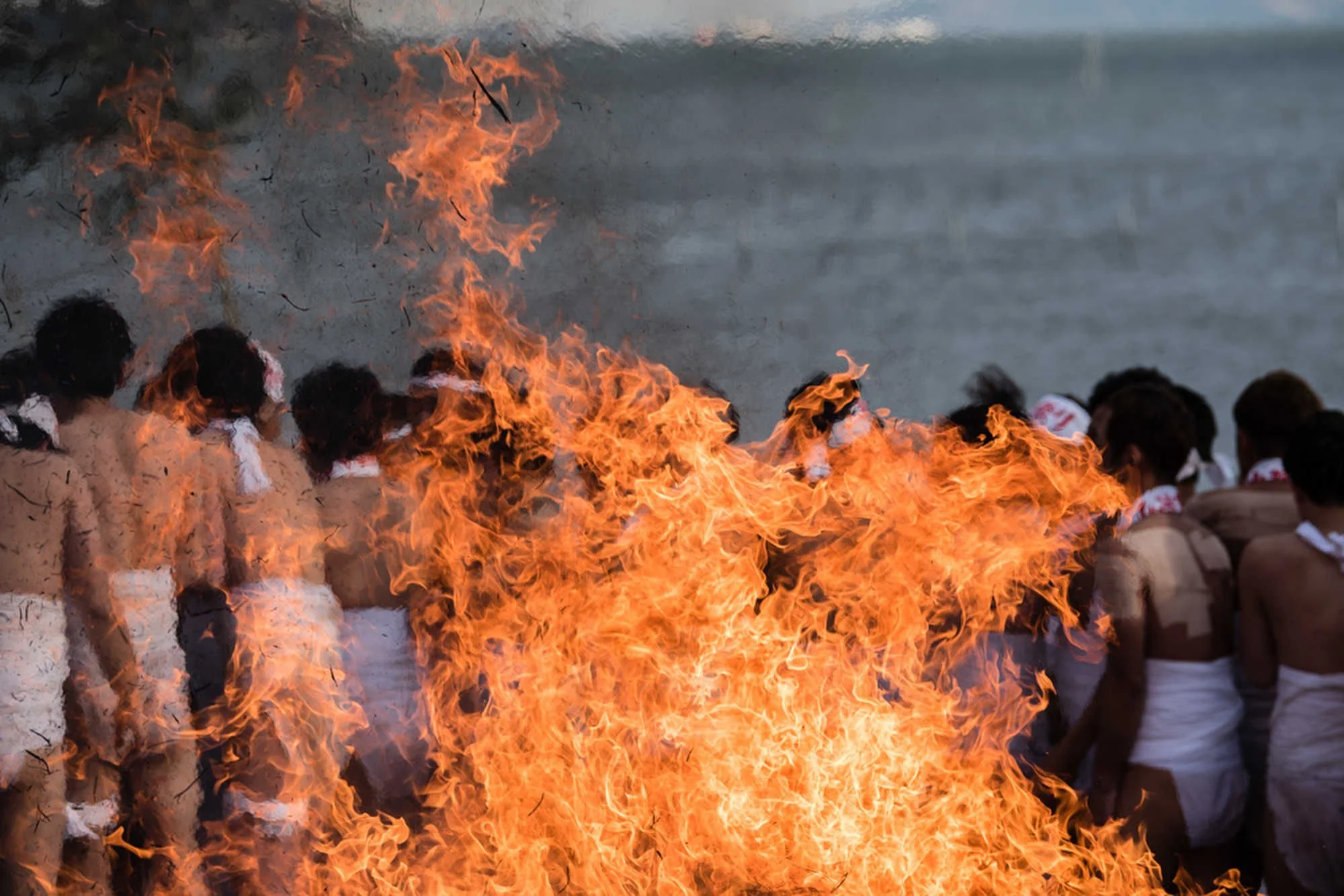 Group of men participating in fire ritual at traditional Japanese festival