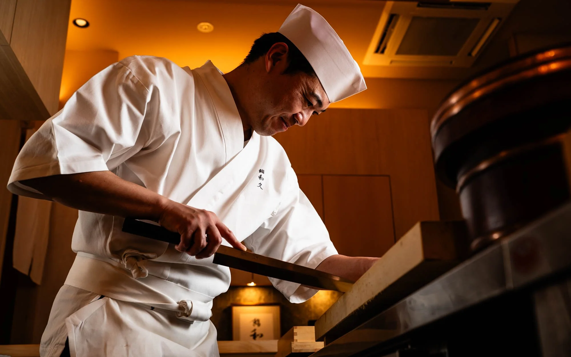 Tokyo sushi chef cutting sashimi at Sushi Waku.