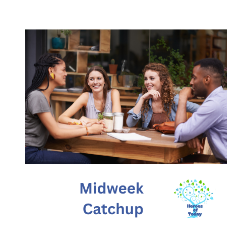 Four young adults sitting at a table, smiling and talking in a casual indoor setting