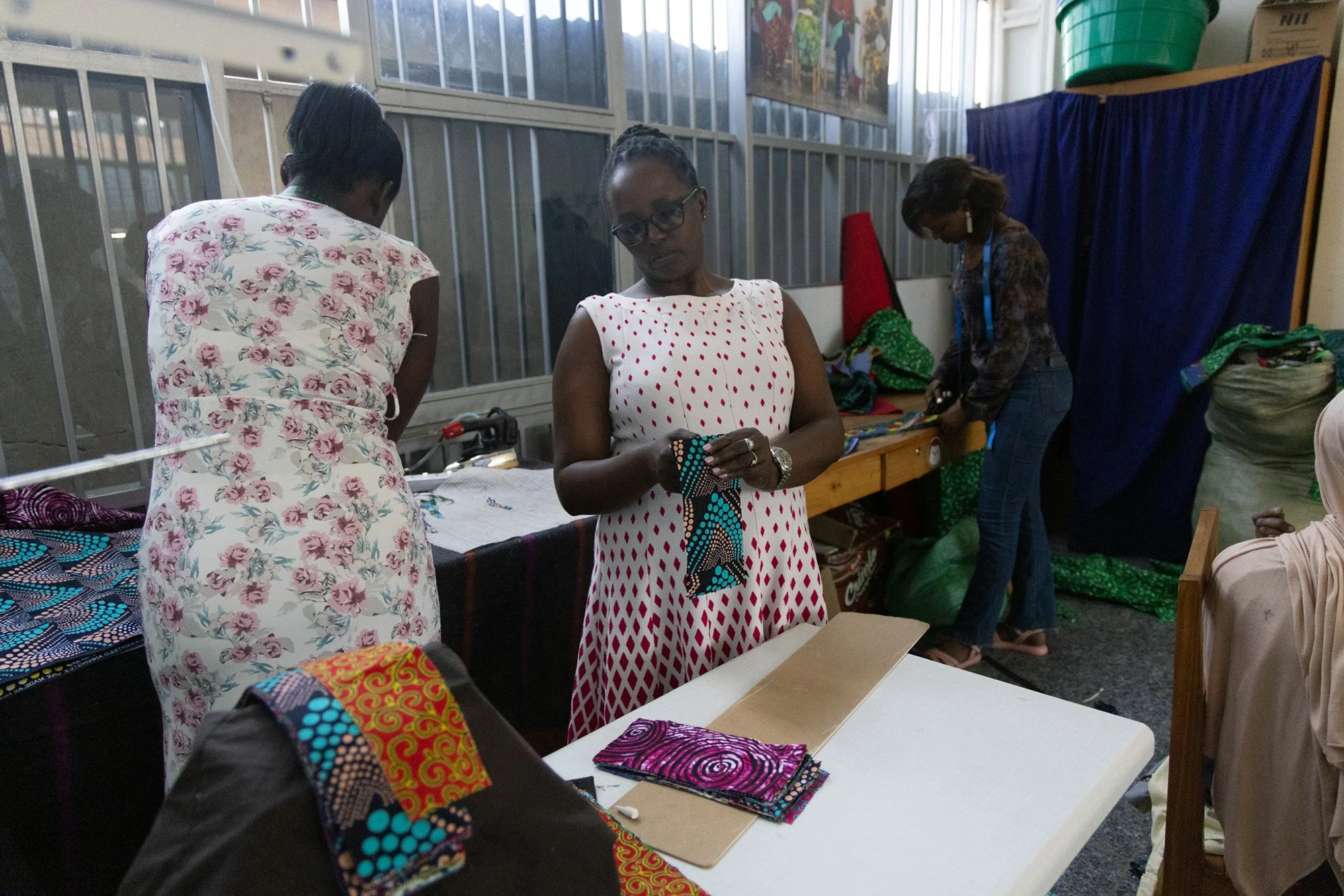 Mary Nyangoma, Project Manager of the Nyamirambo Women’s center, organizes different pieces of clothing for the store on July 6, 2024, in Kigali, Rwanda.  
