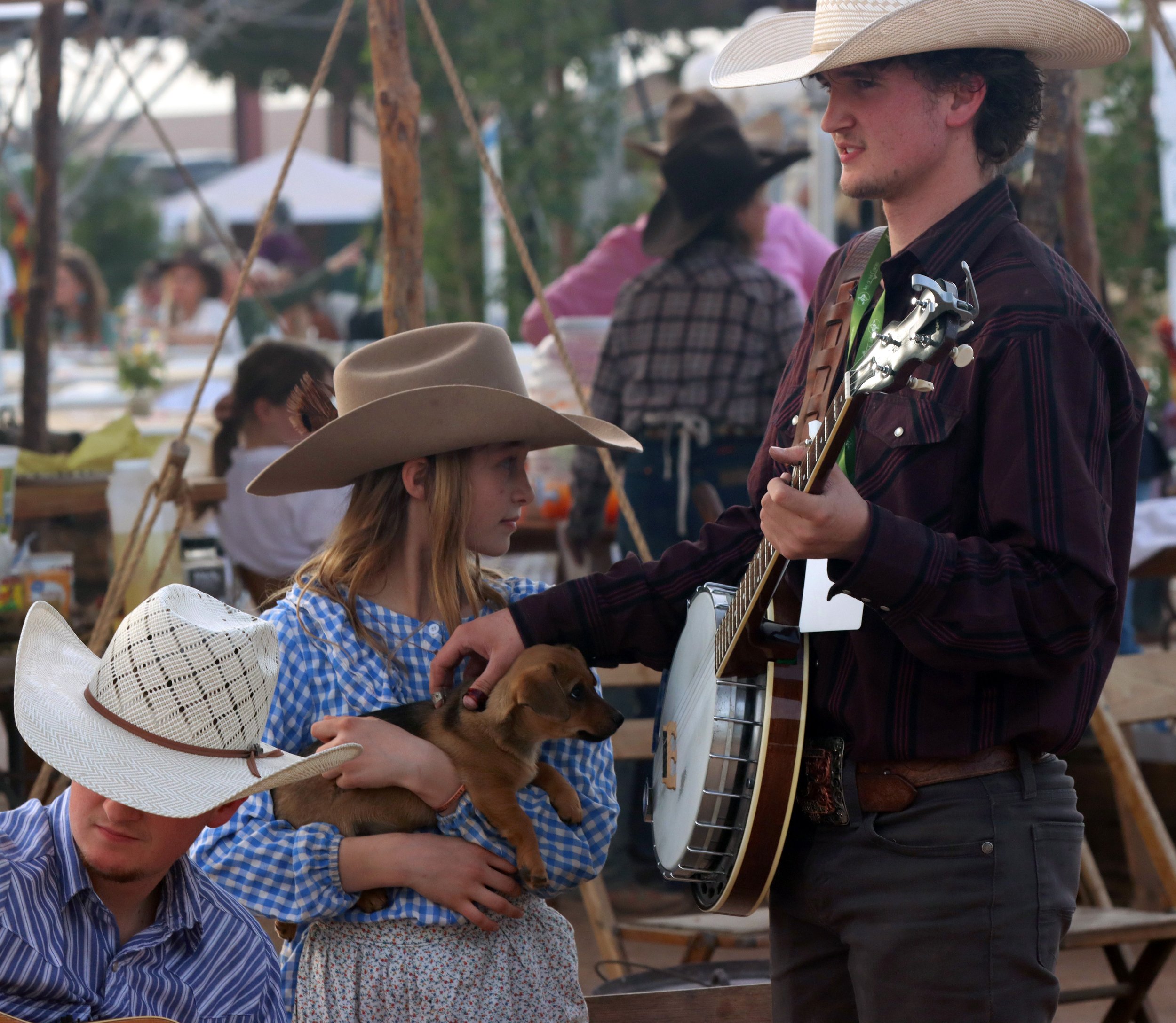 From left, Ashton Richardson, Anne Mae Reed and Devin Richardson take a break with their band, The Reed Family, on Jan. 19, 2024, at Art of the Cowgirl in Queen Creek. The band started playing in 1994, when violins were given to some of the family fo