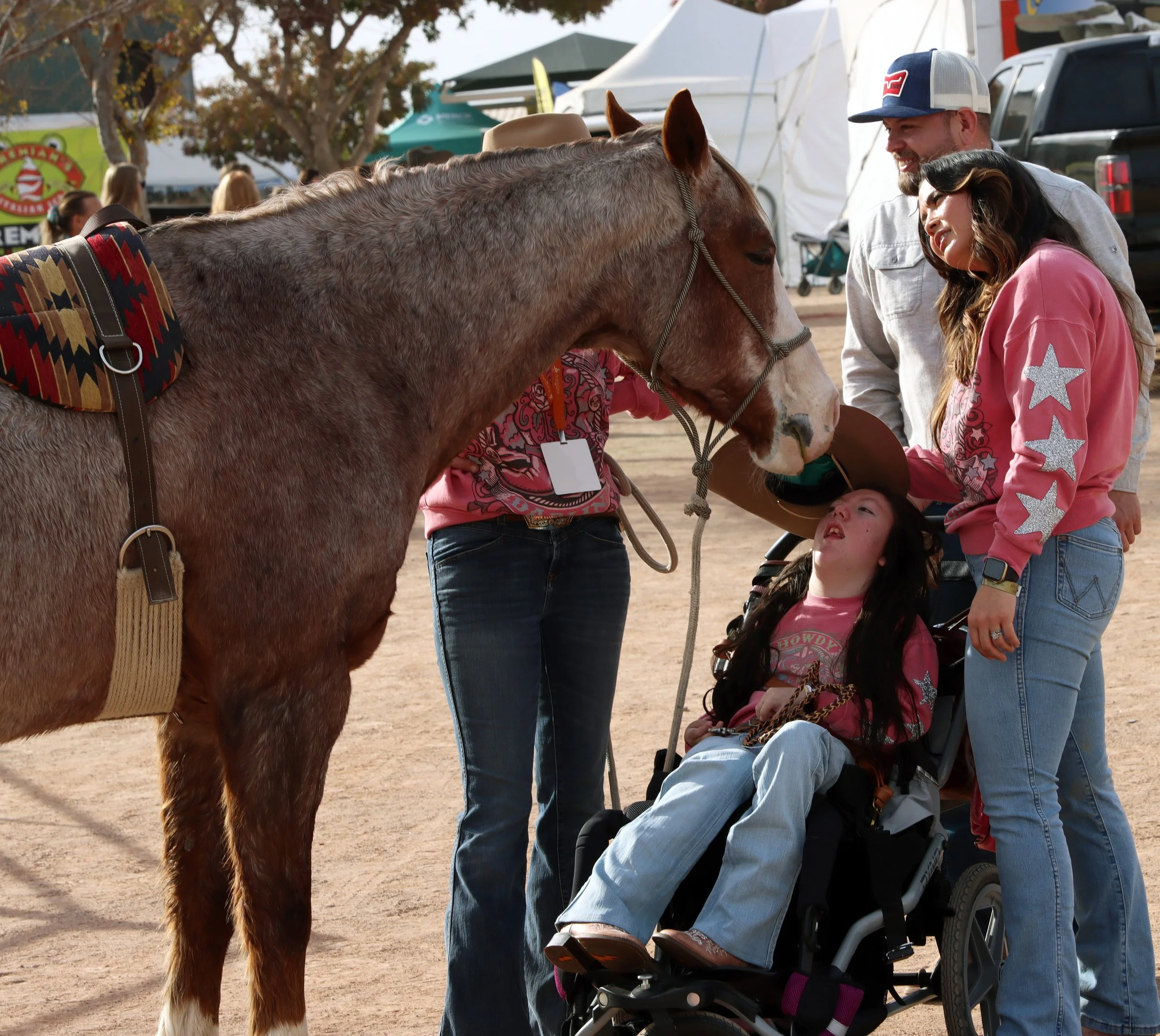Clockwise from top right, Arthur Lujan, Jennifer Lujan and Betty Lujan interact with horses on Jan. 19, 2024. Beth Godbey, who handled the horse, did a demonstration at Art of the Cowgirl showcasing the importance of connection with horses. The demon