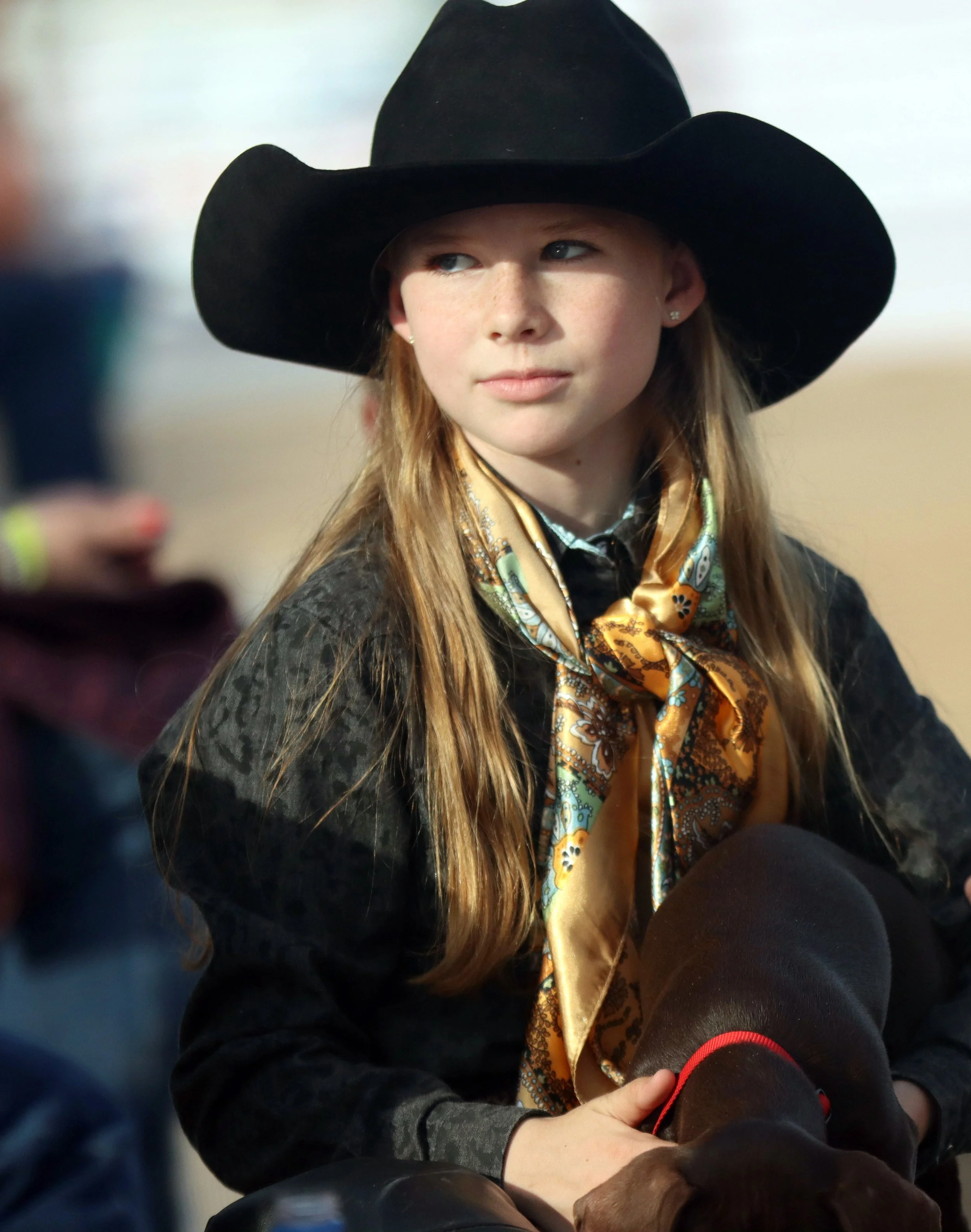 Lizee Jo Bradshaw, 9, pets dog at Art of the Cowgirl on Jan. 19, 2024. 