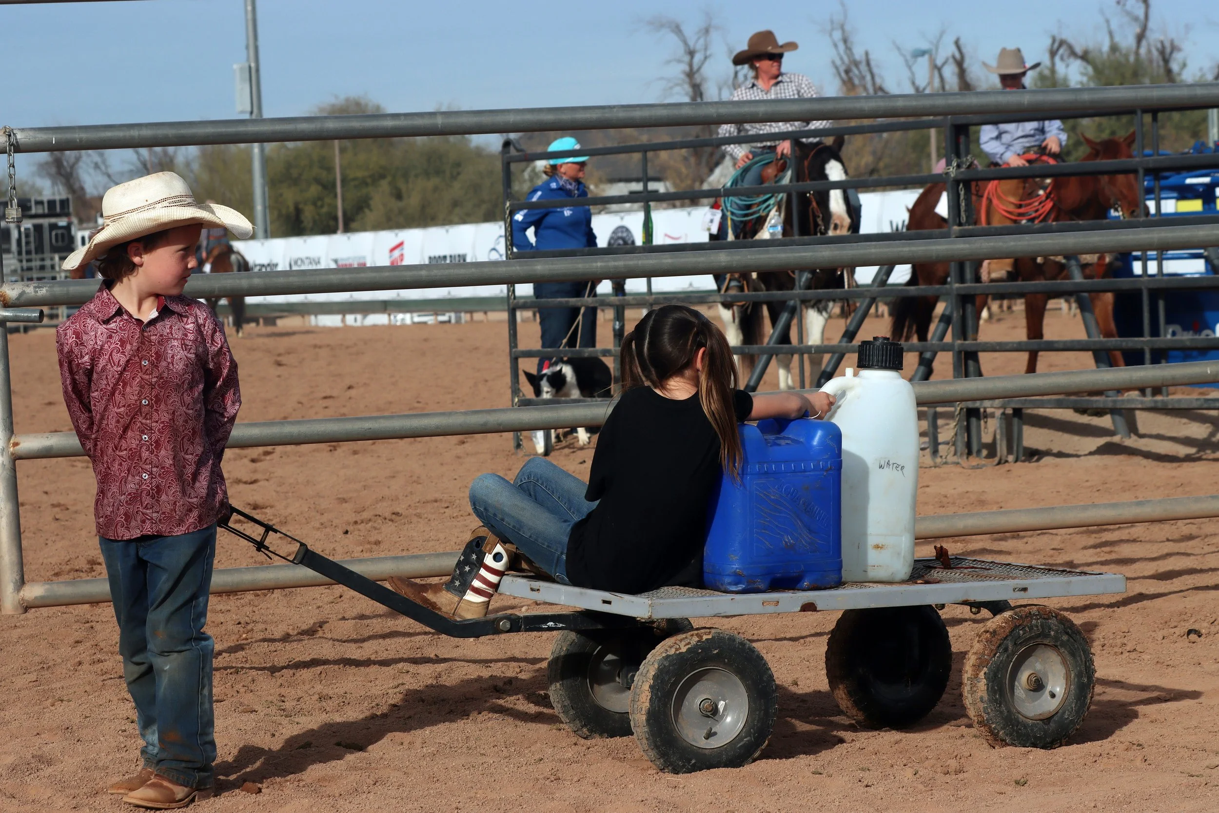 Waylon Kenny pulls Breckin Reed in a wagon at Art of the Cowgirl on Jan. 19, 2024, in Queen Creek