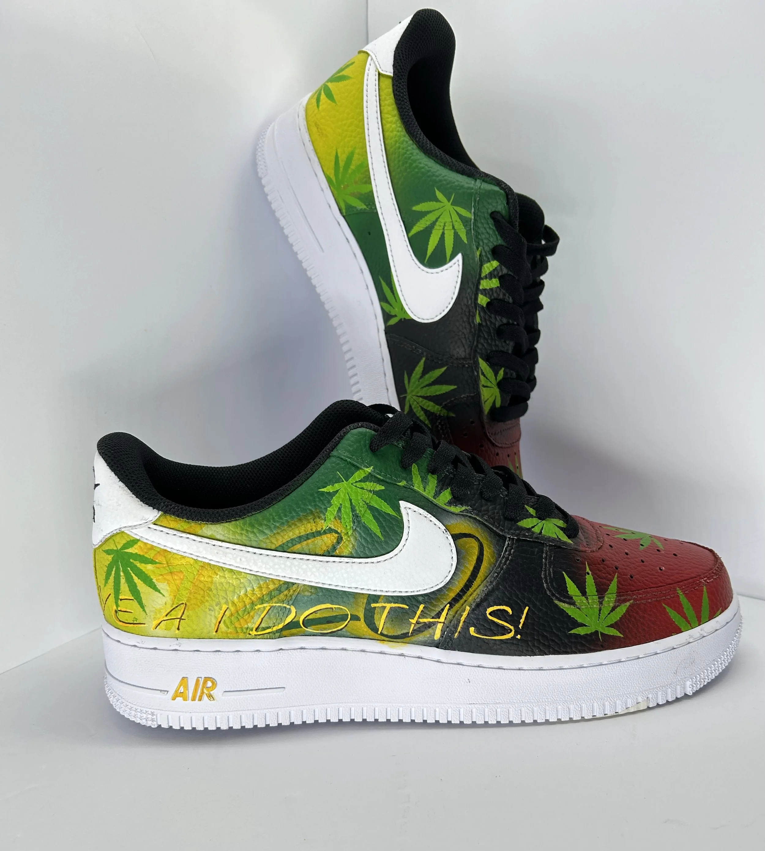 Colorful Nike Air sneakers with marijuana leaf designs and the words "EAD OTHS" on the side.