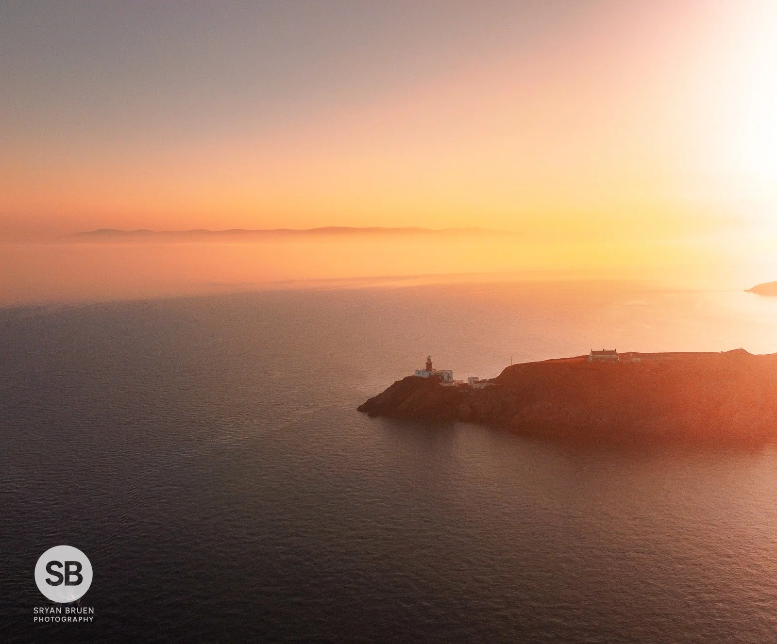 2022-03-28 Baily Lighthouse golden fog sunset 28 March 2022.jpg