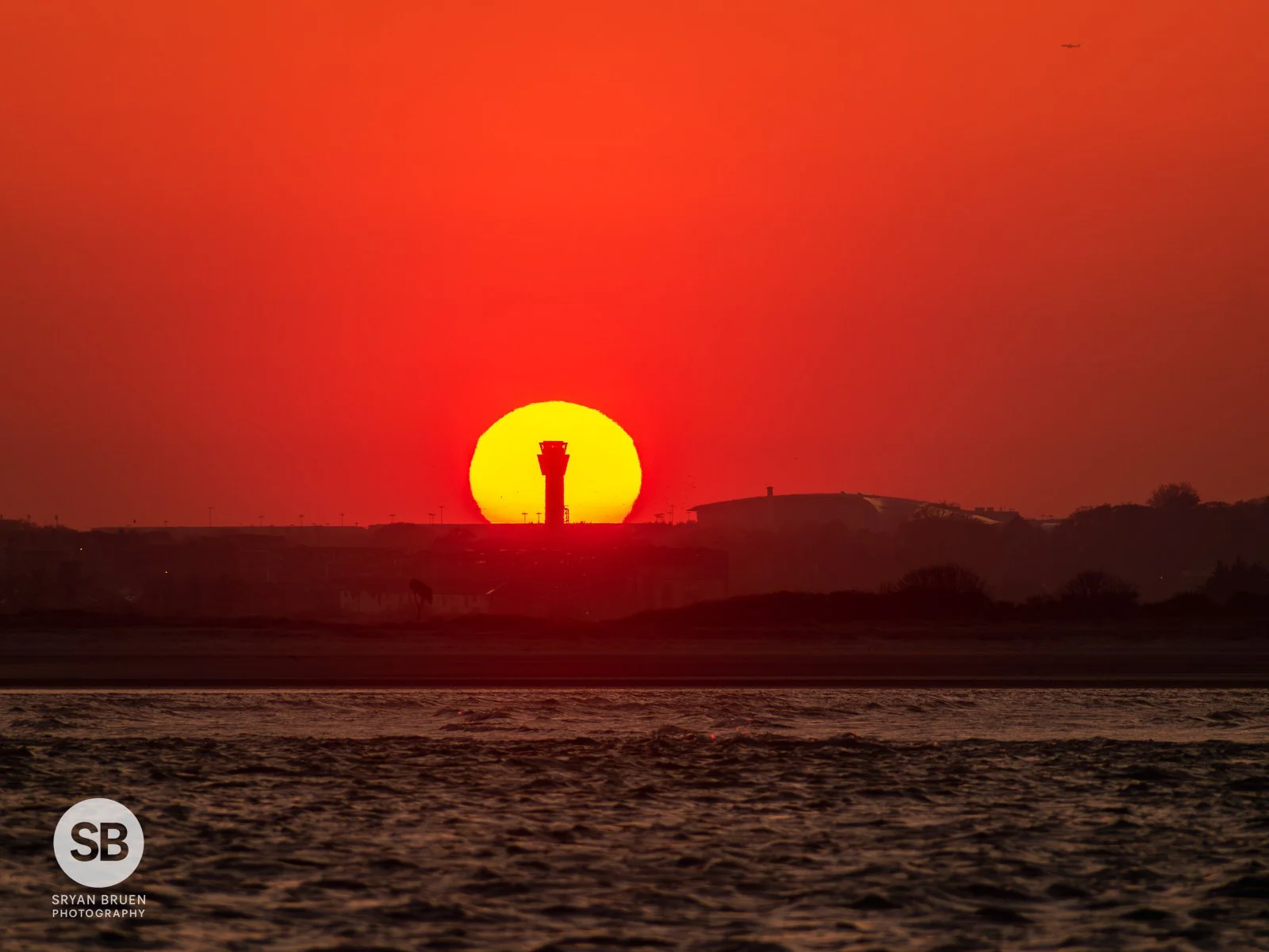 2023-04-18 Dublin Airport control tower sunset from Burrow Beach 18 April 2023.jpg