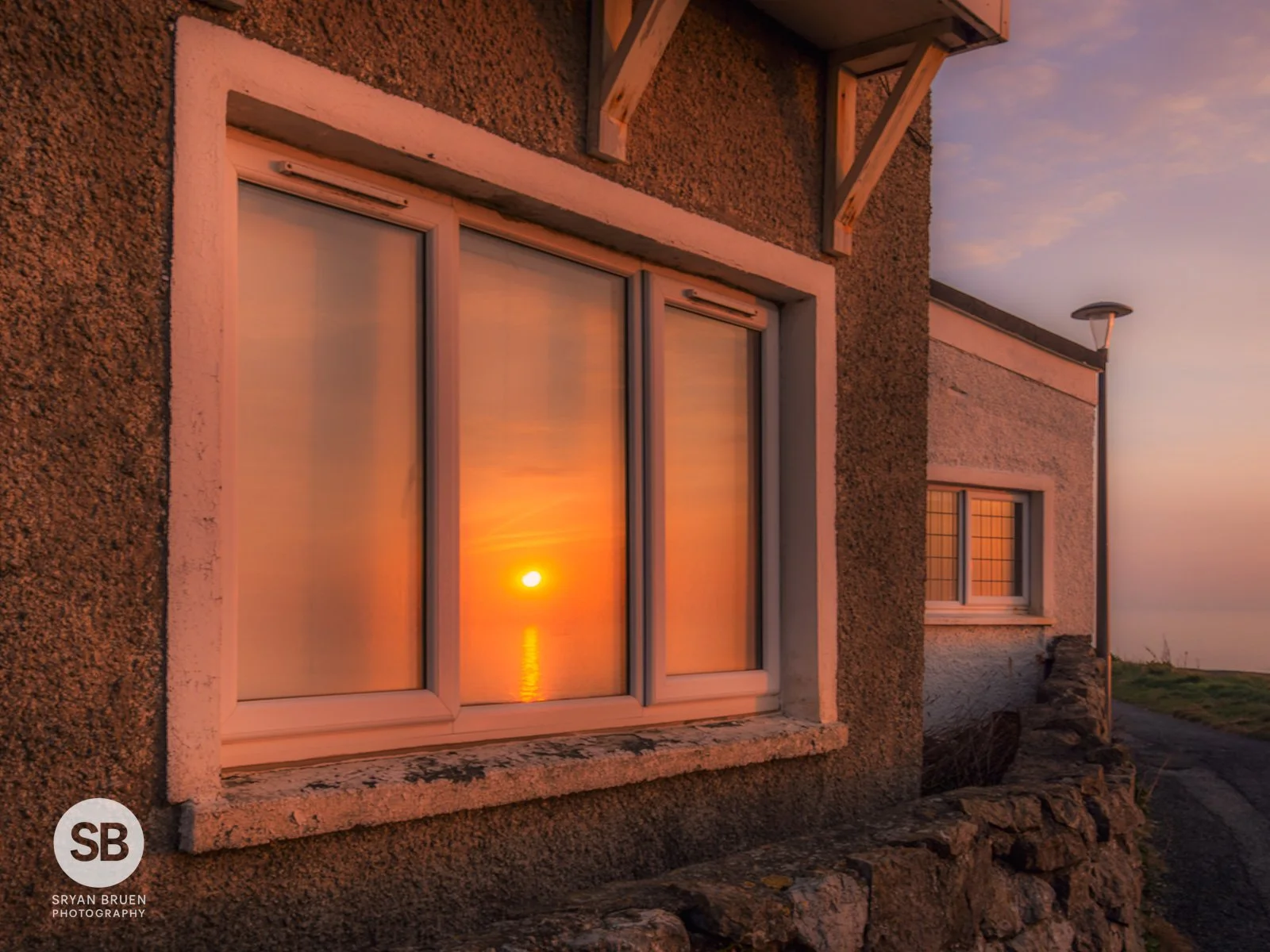 2025-03-20 Portmarnock martello window sunrise reflection.jpg