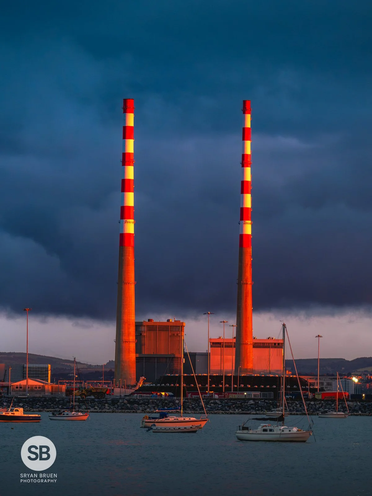 2026-08-09 Poolbeg Chimneys golden light at sunset from Clontarf.jpg