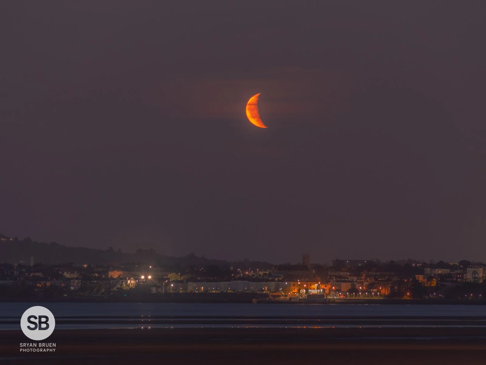 2025-03-24 Crescent moonrise over Blackrock from Sandymount 24 March 2025.jpg