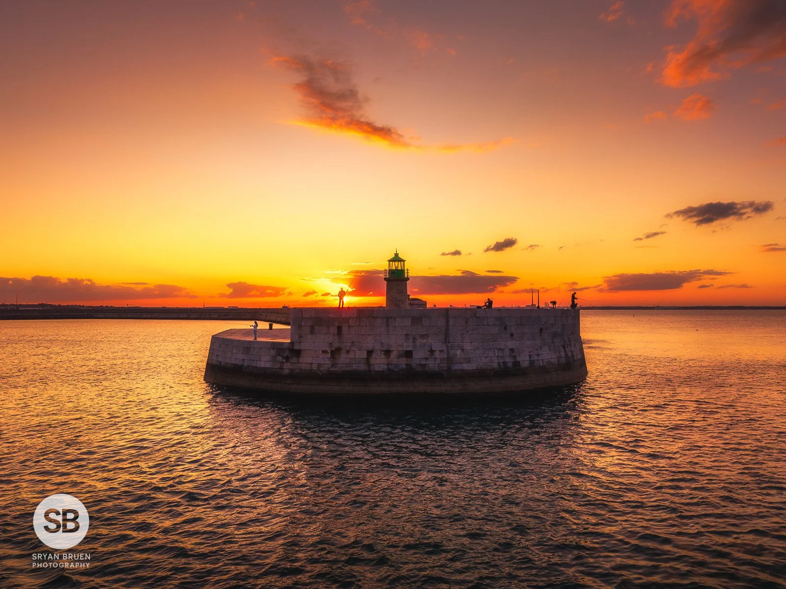 2025-08-08 Dun Laoghaire West Pier lighthouse sunset silhouettes.jpg
