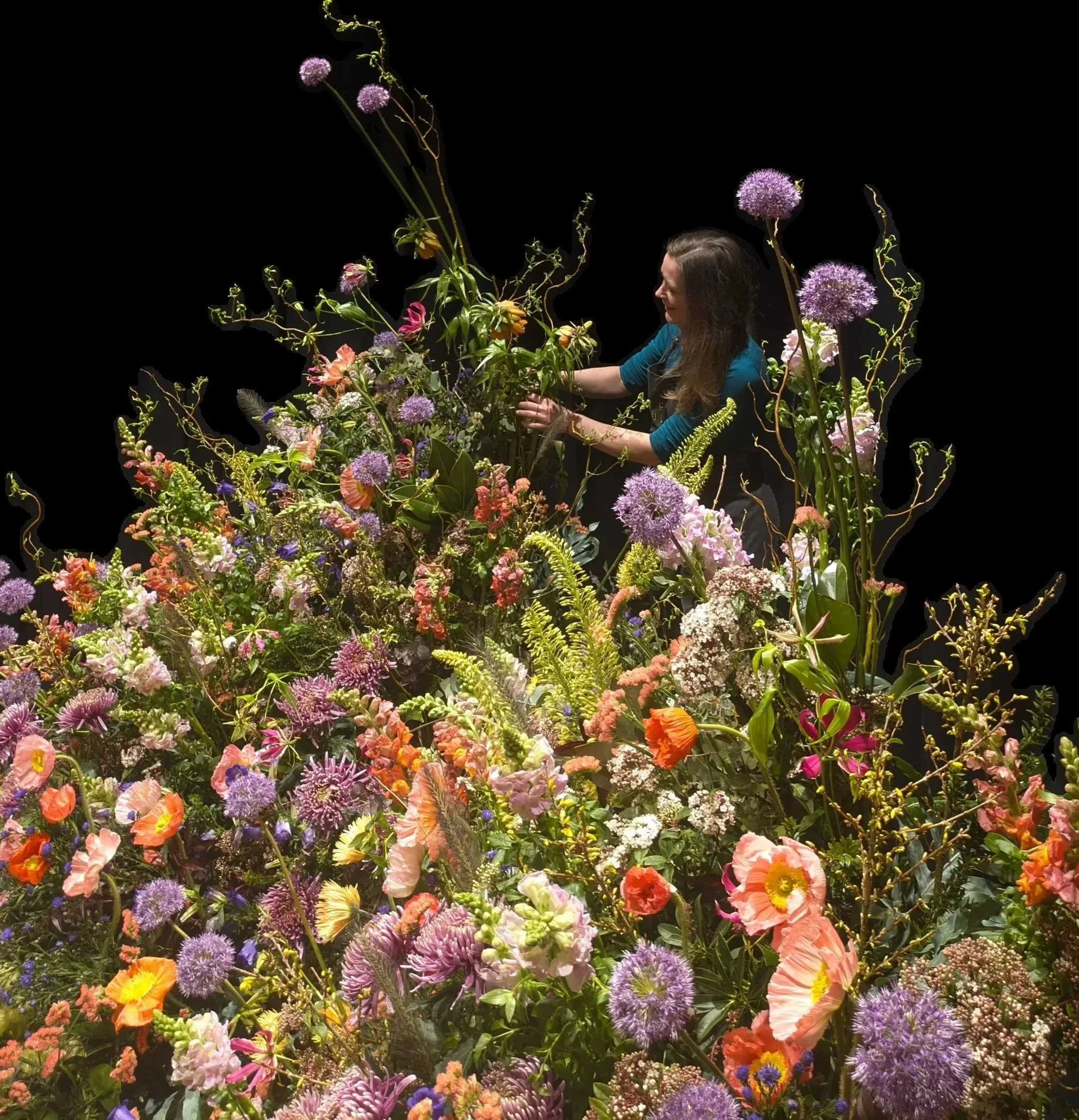 Berlin base Meike Heller arranging large-scale floral installation with allium and poppies