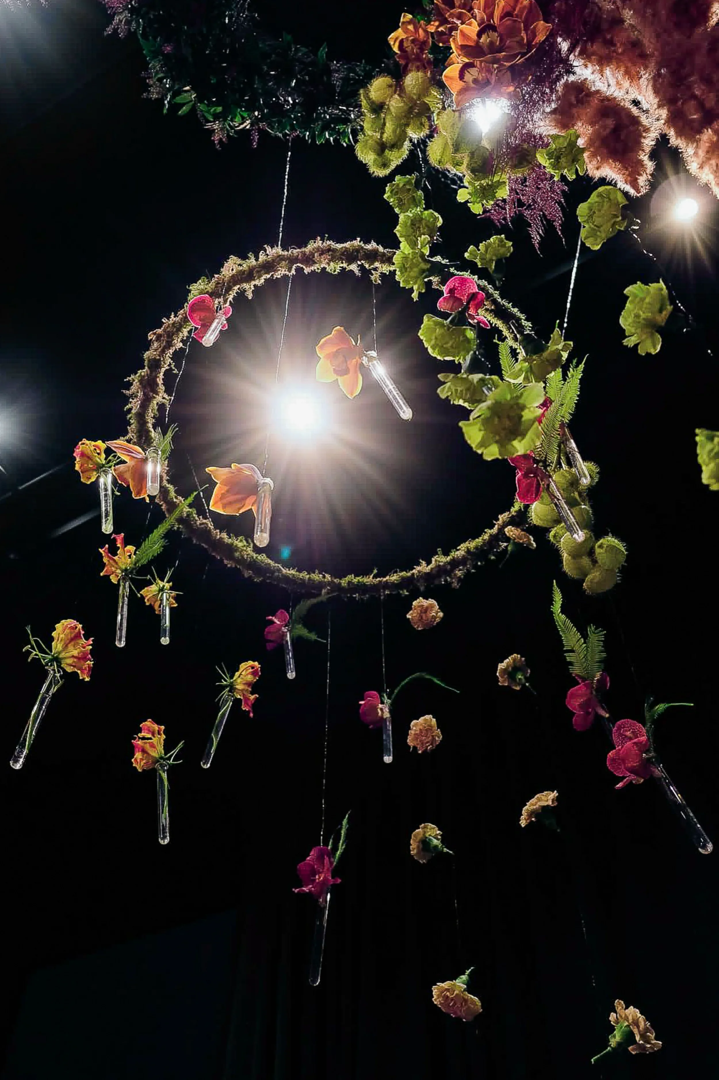 Circular suspended floral installation with orchids and anthurium, McQueens London 2025