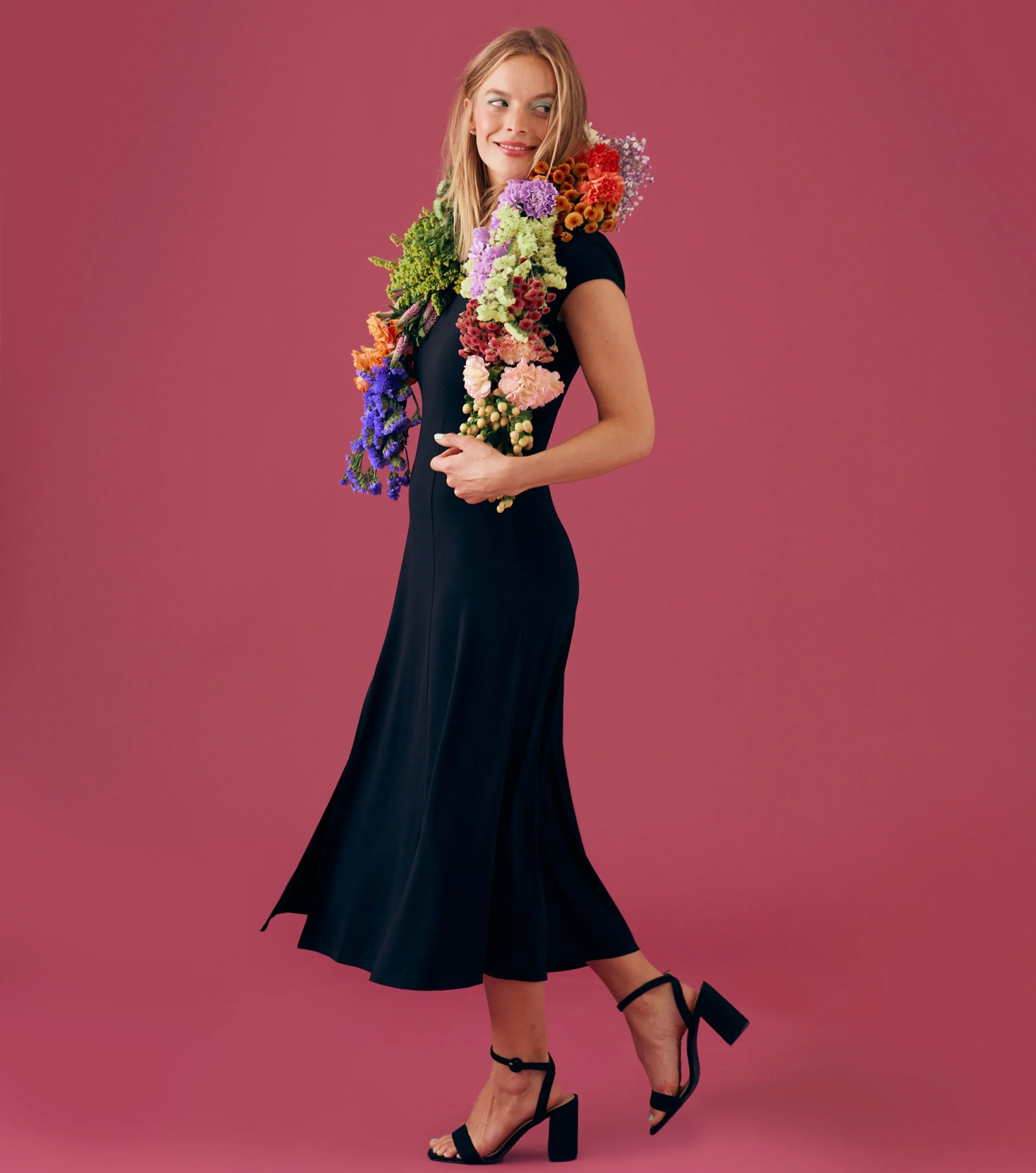 Model holding floral garland with ranunculus and tulips, Les Lunes fashion photoshoot Berlin