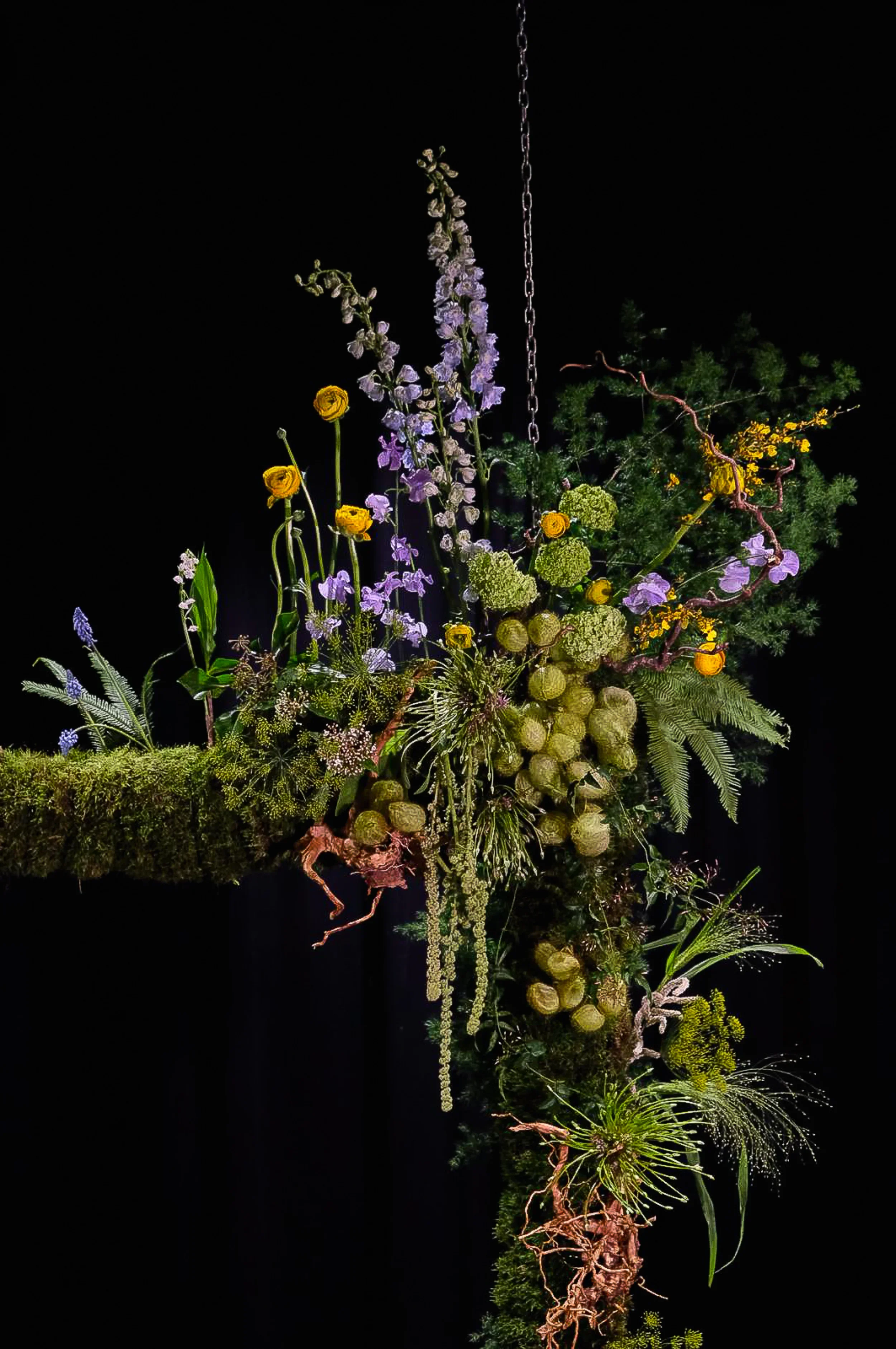 Suspended floral installation with ranunculus, delphinium and moss, McQueens Flower School London