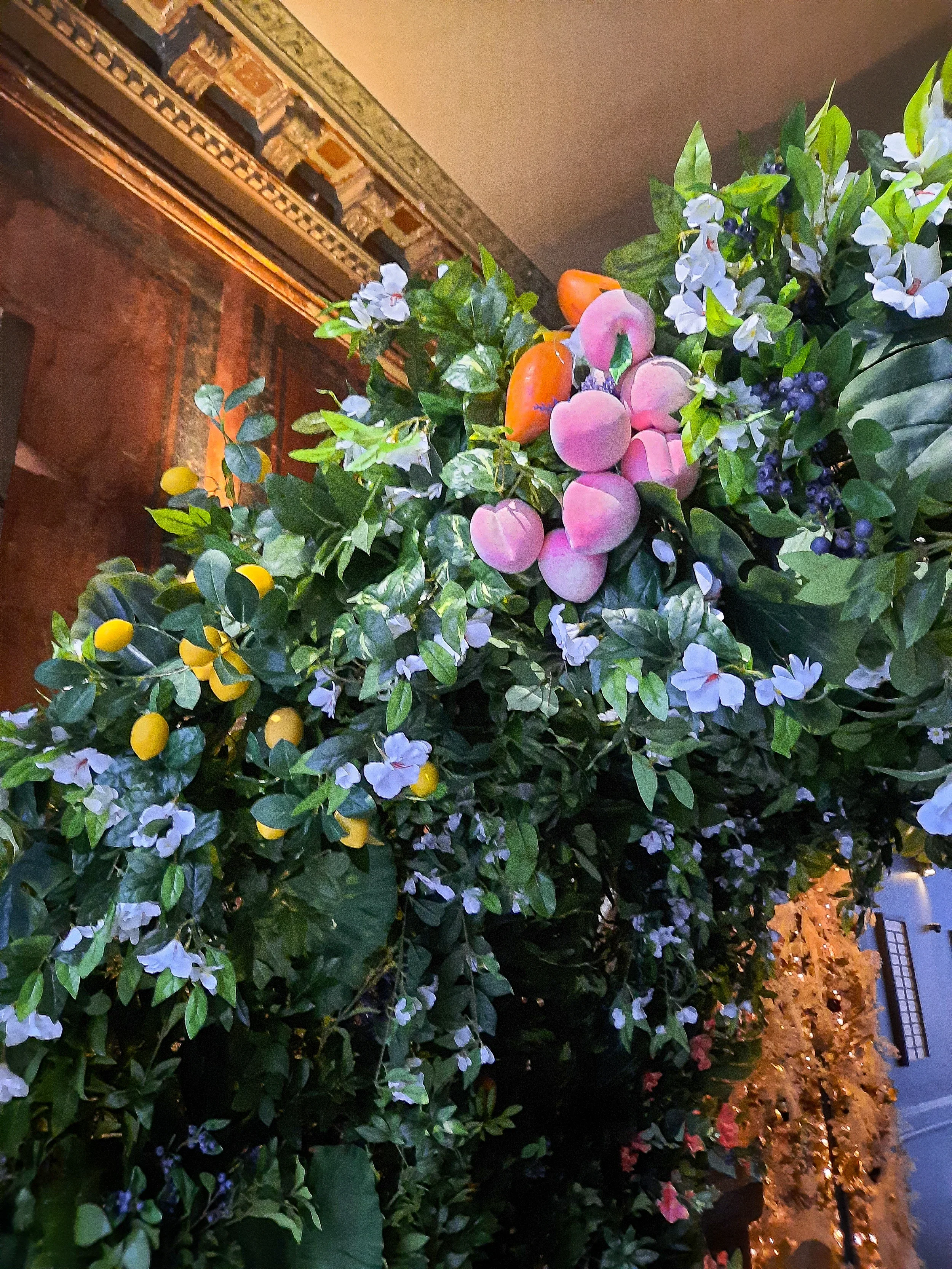 Close-up of flower arch with peach, lavender and monstera leaf, Fuze Tea event Berlin 2024