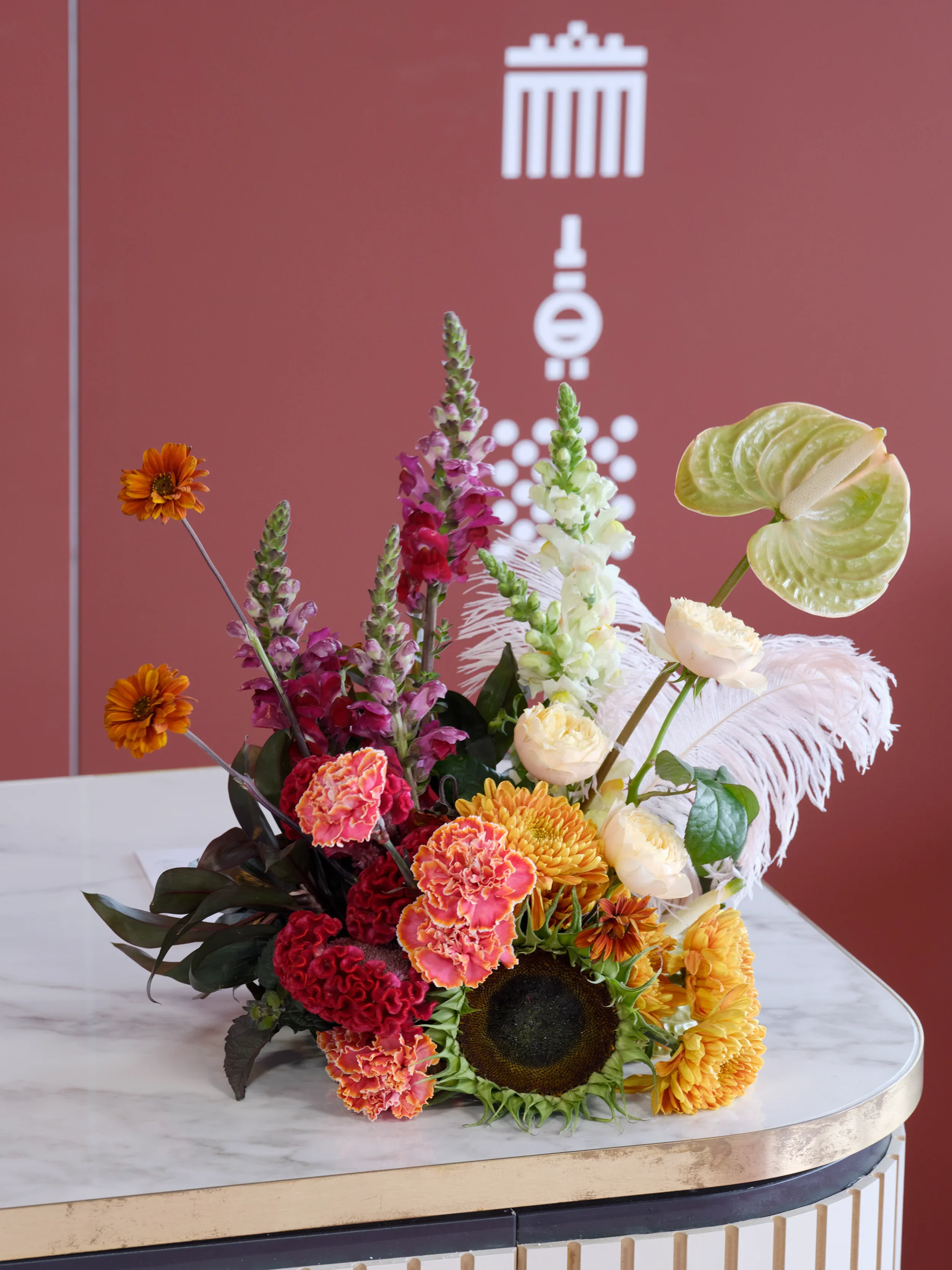 Floral installation with helianthus, anthurium and lisianthus on marble surface at Formula E Berlin 2025 event design