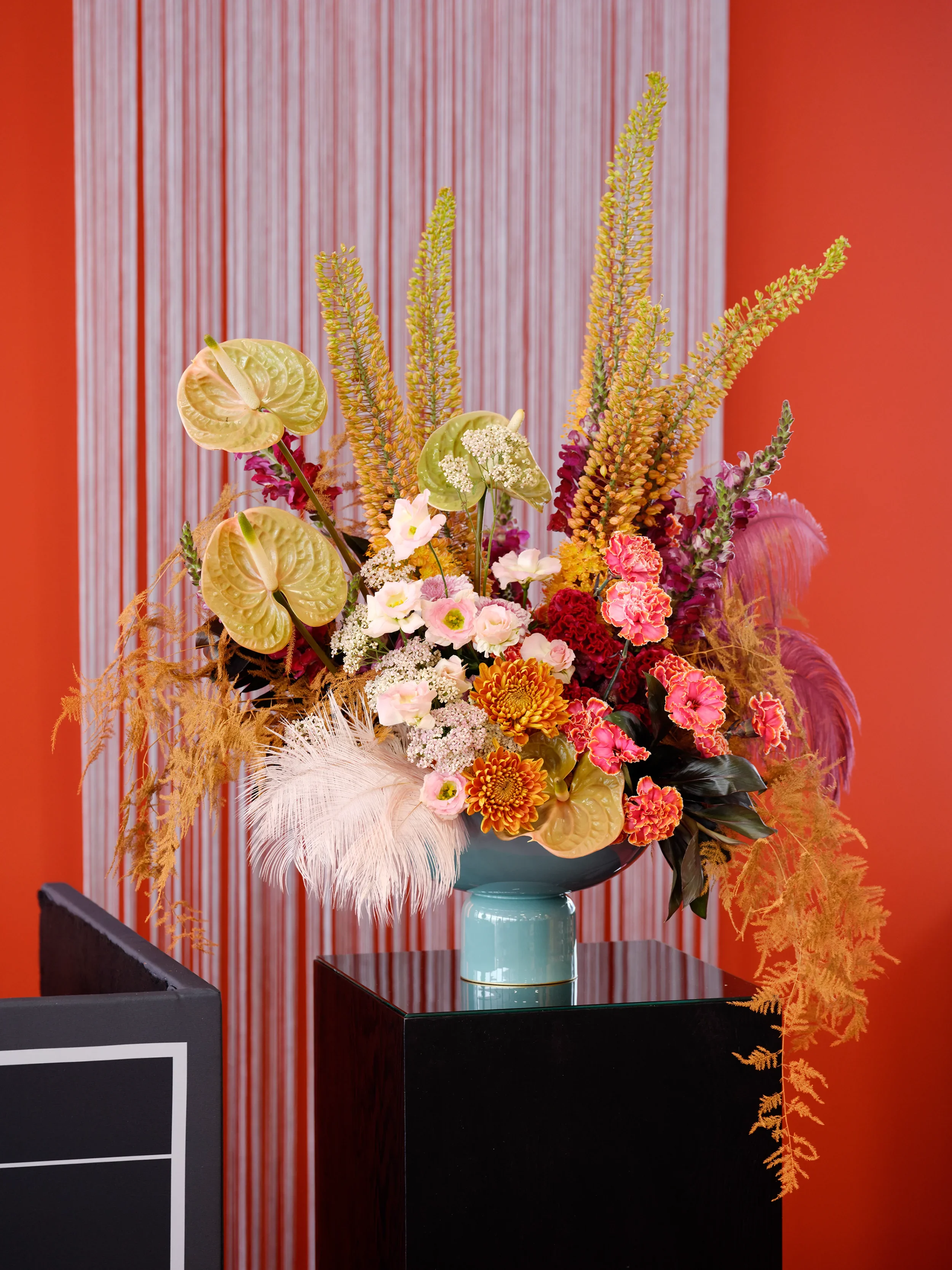 Floral installation with anthurium, eremurus and feathers at Formula E Berlin 2025, Tempelhofer Feld