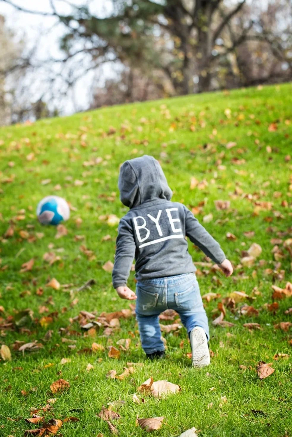 Child wearing a gray hoodie with