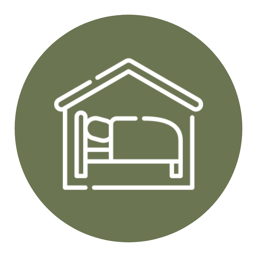 Line drawing of a bed inside a small house with a sloped roof, on a green circular background.