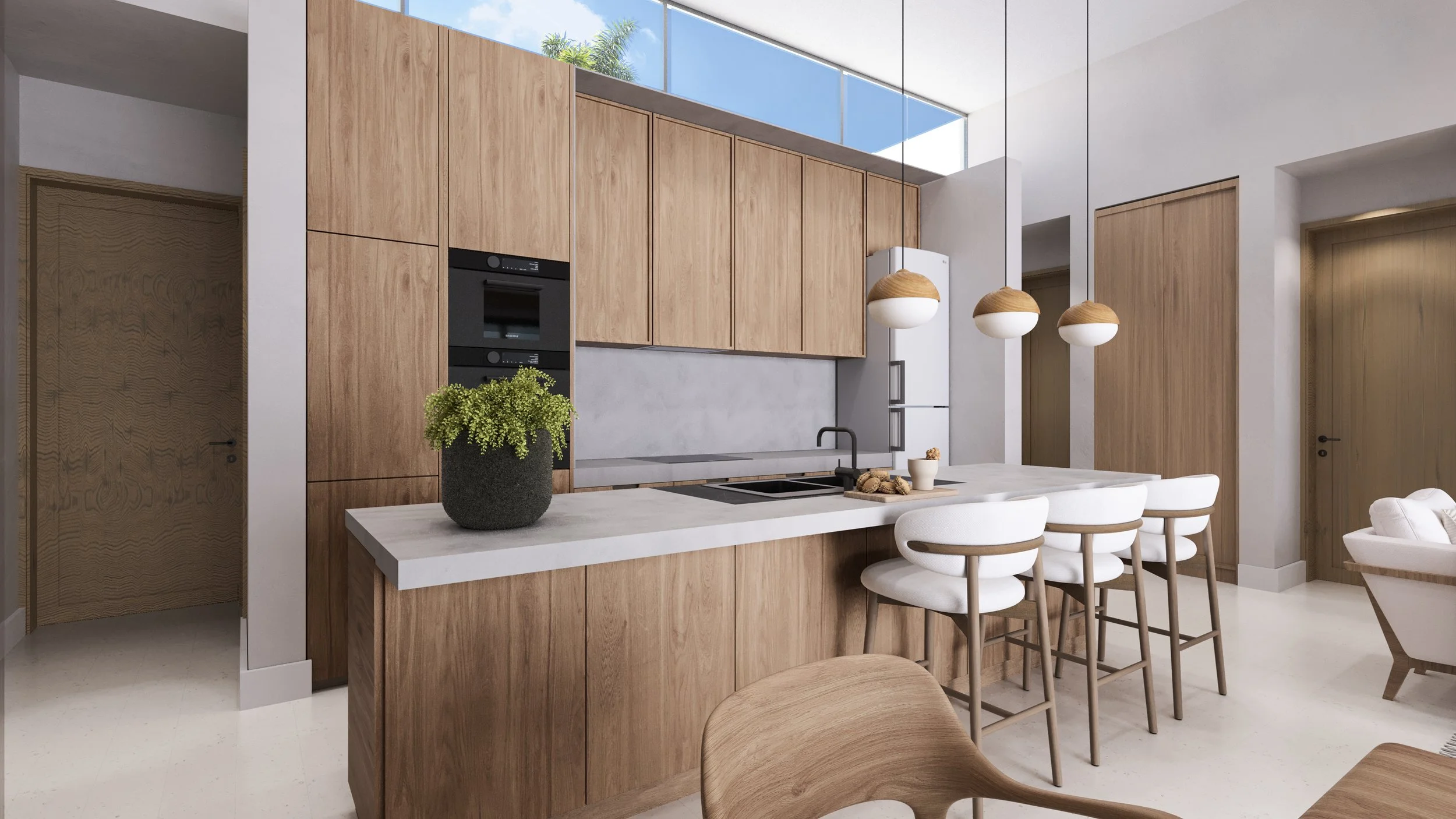 Modern kitchen with light wood cabinets, white countertops, and four white barstools with wooden legs at a kitchen island. Three hanging pendant lights above the island, a built-in oven, and a potted plant are also visible.