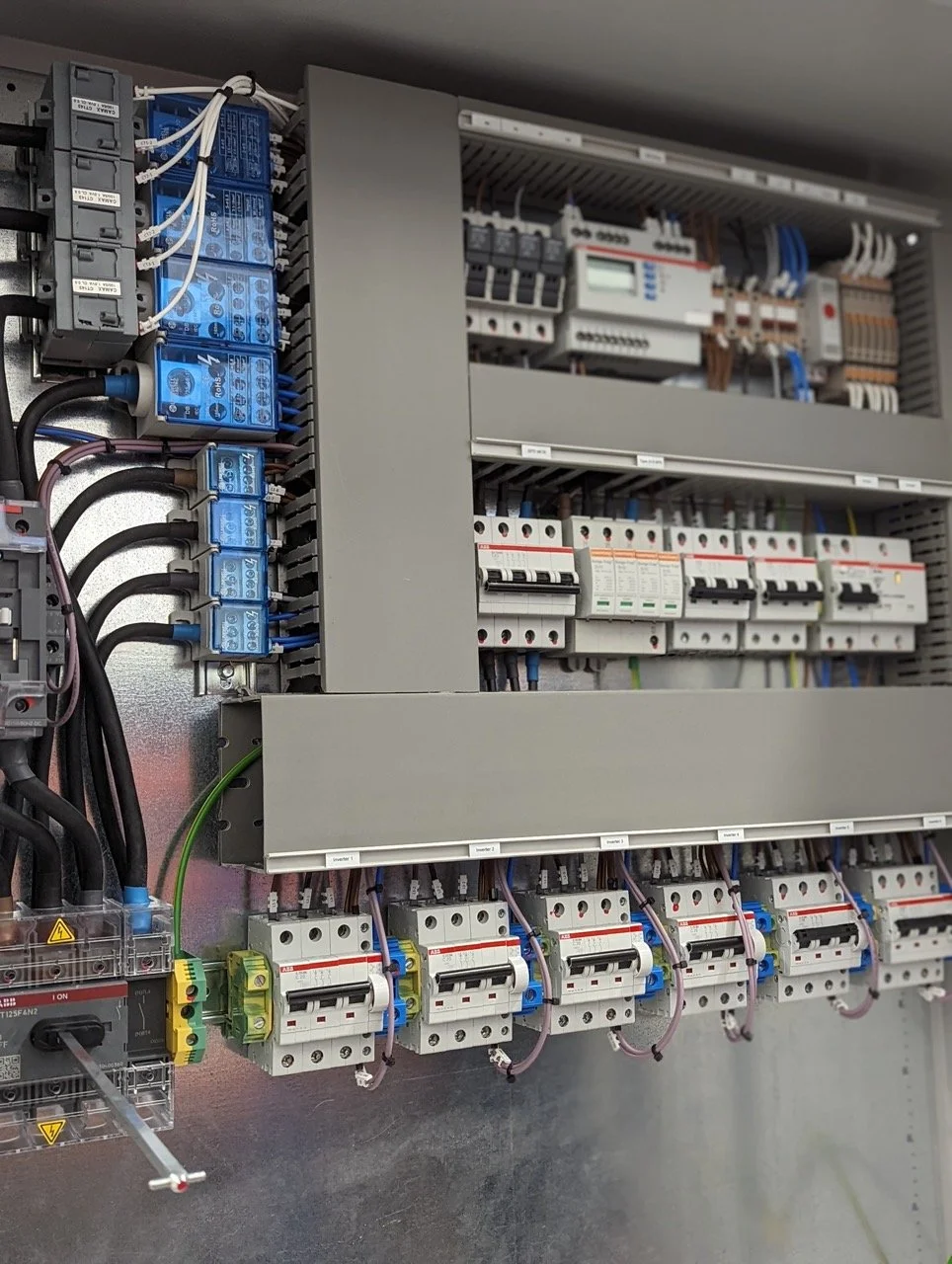 Solar PV Distribution Boards that save you time supplied by G59 Projects, Cheshire. Electrical control panel with relays, circuit breakers, and wiring.
