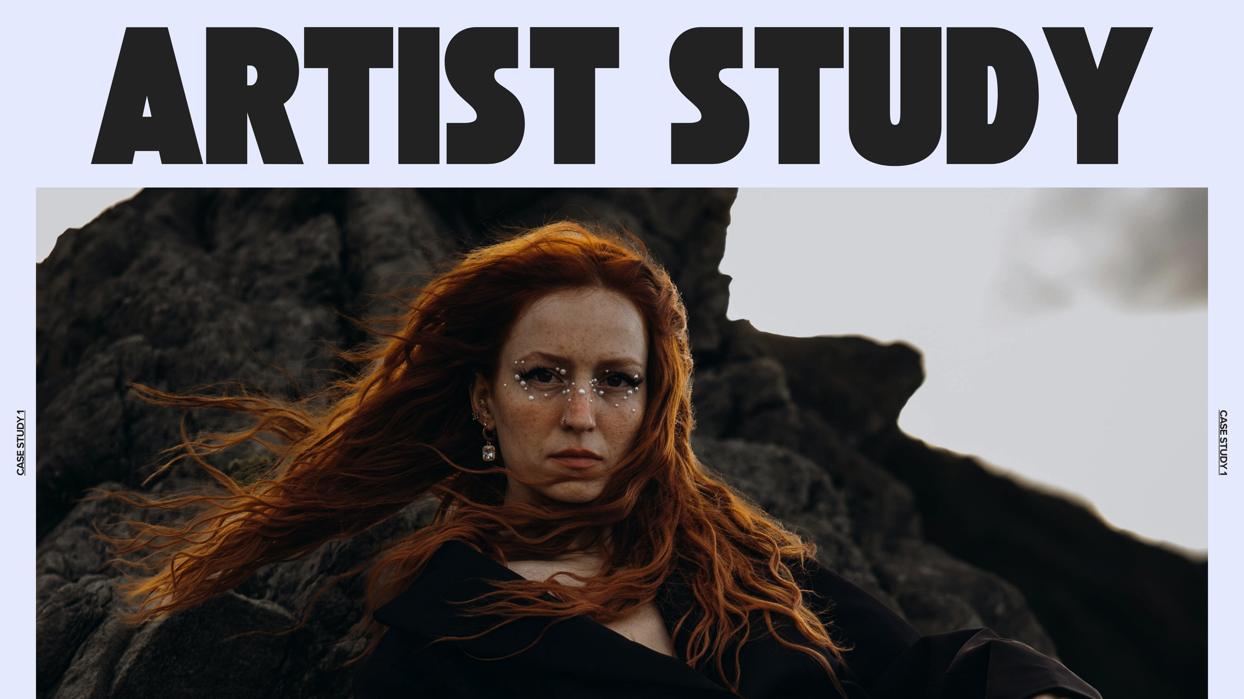 A woman with red hair, decorated with small stars and rhinestones around her eyes, stands against a rocky landscape with an overcast sky in the background.