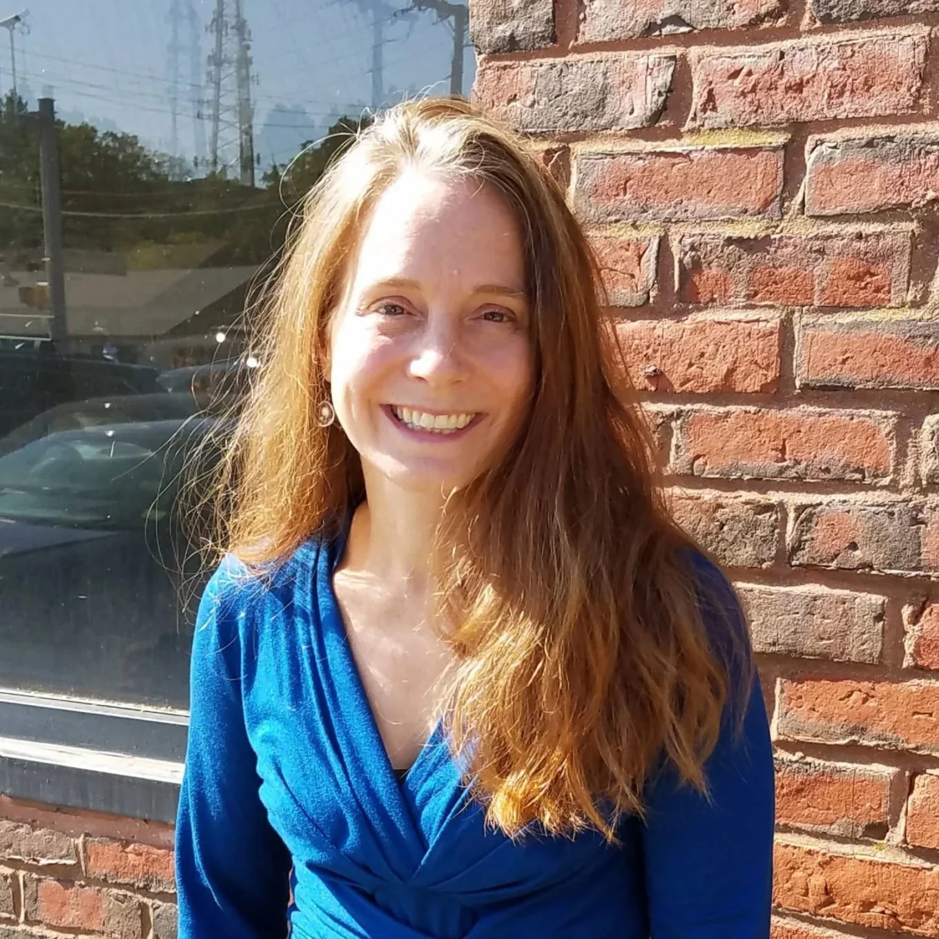Joanna Bridger smiling in blue dress