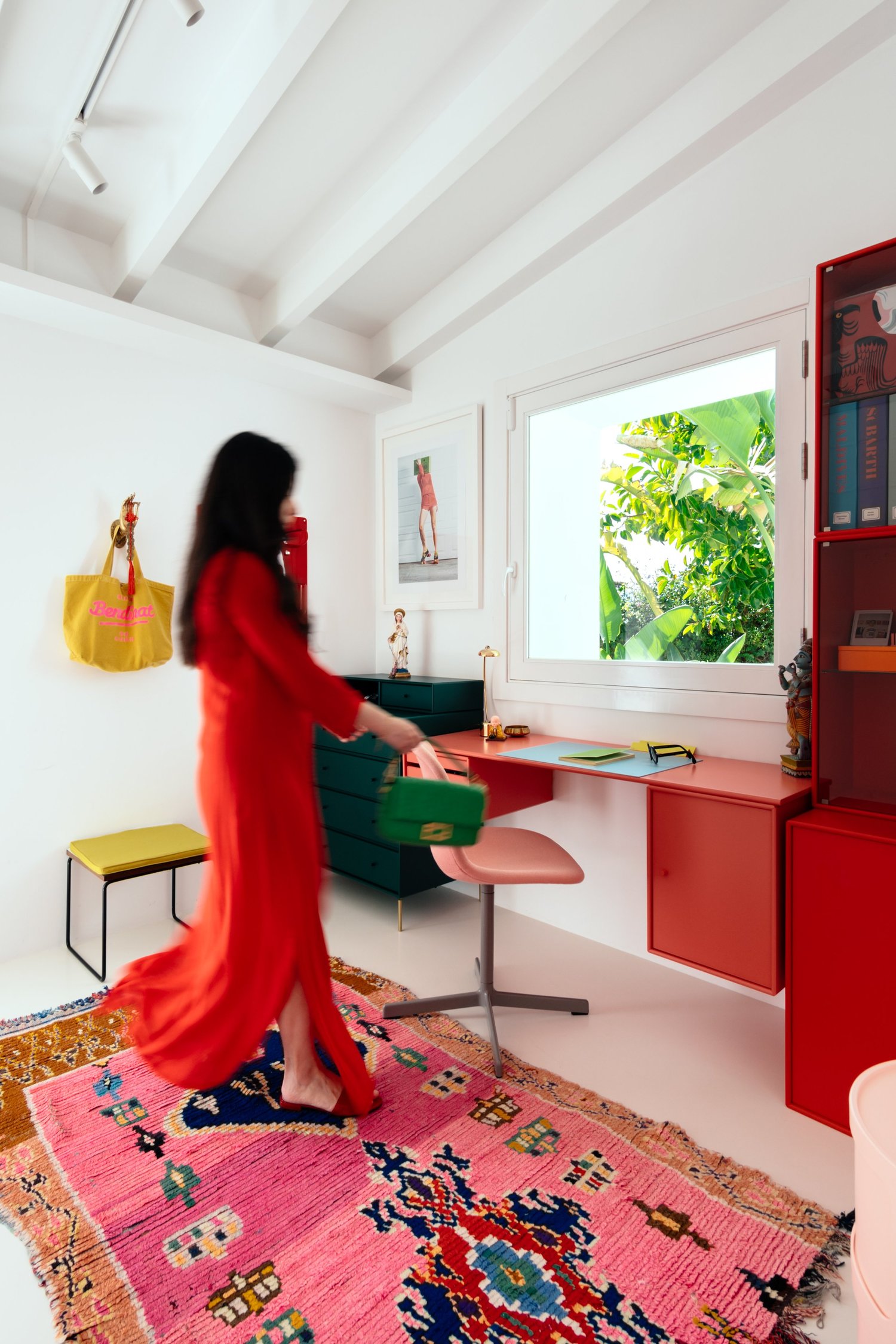 Colourful home office with a woman in a red dress, photographed by Vladimir Vladimirov