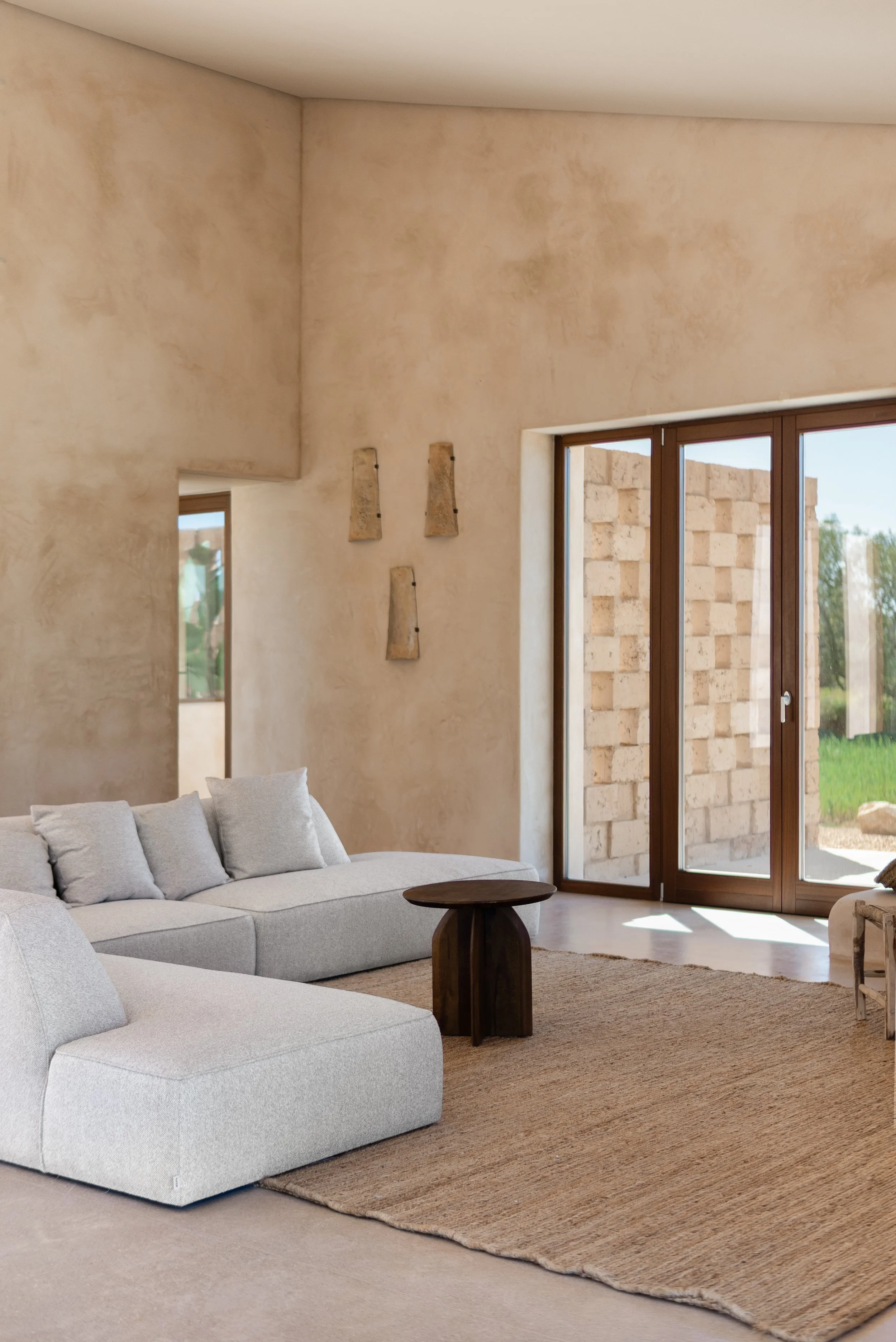 Open-plan living space with polished concrete floors and iroko joinery, Cas Concos finca Mallorca