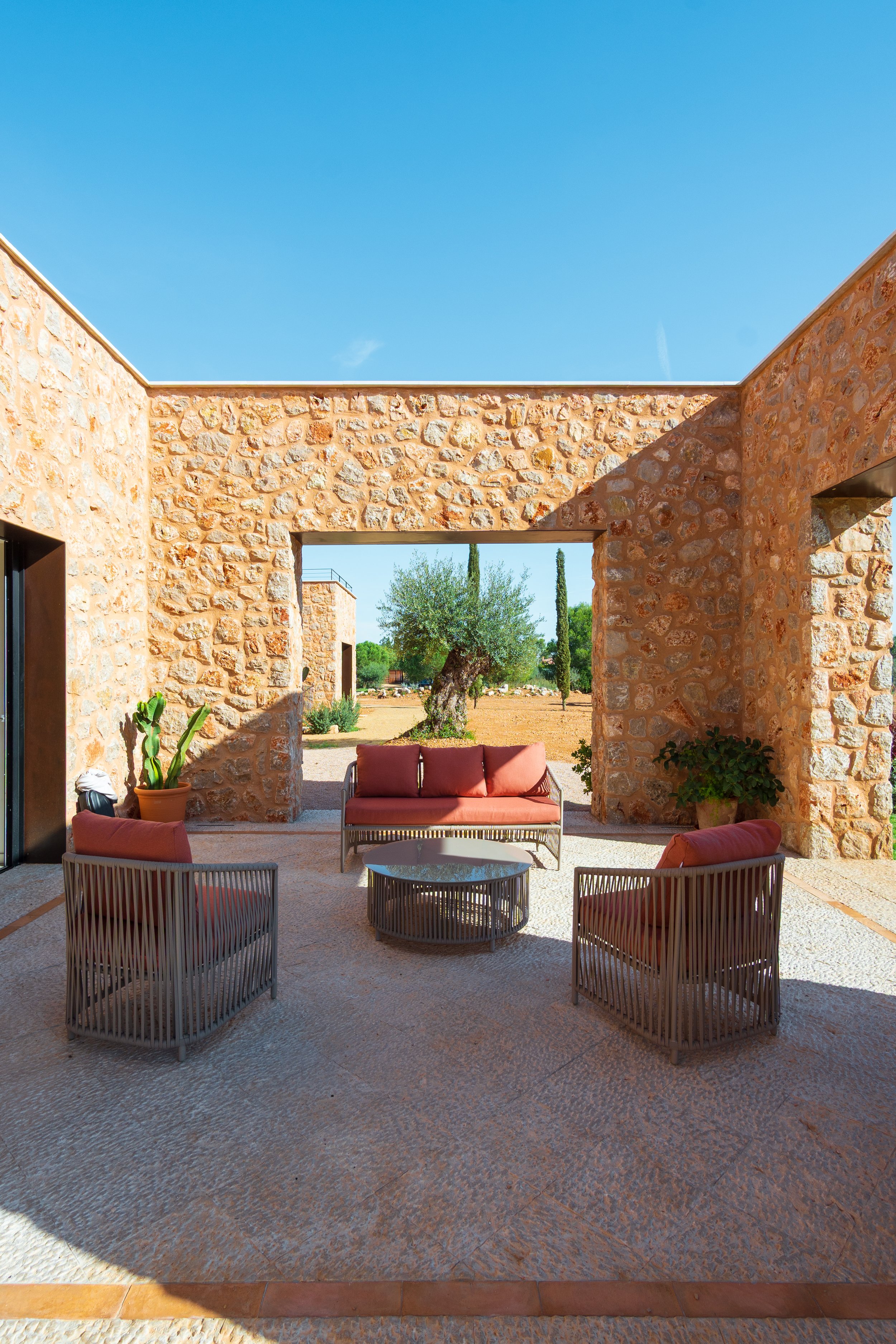 Traditional stone terrace with olive tree views, contemporary Mallorcan finca by Sebastià Muntaner