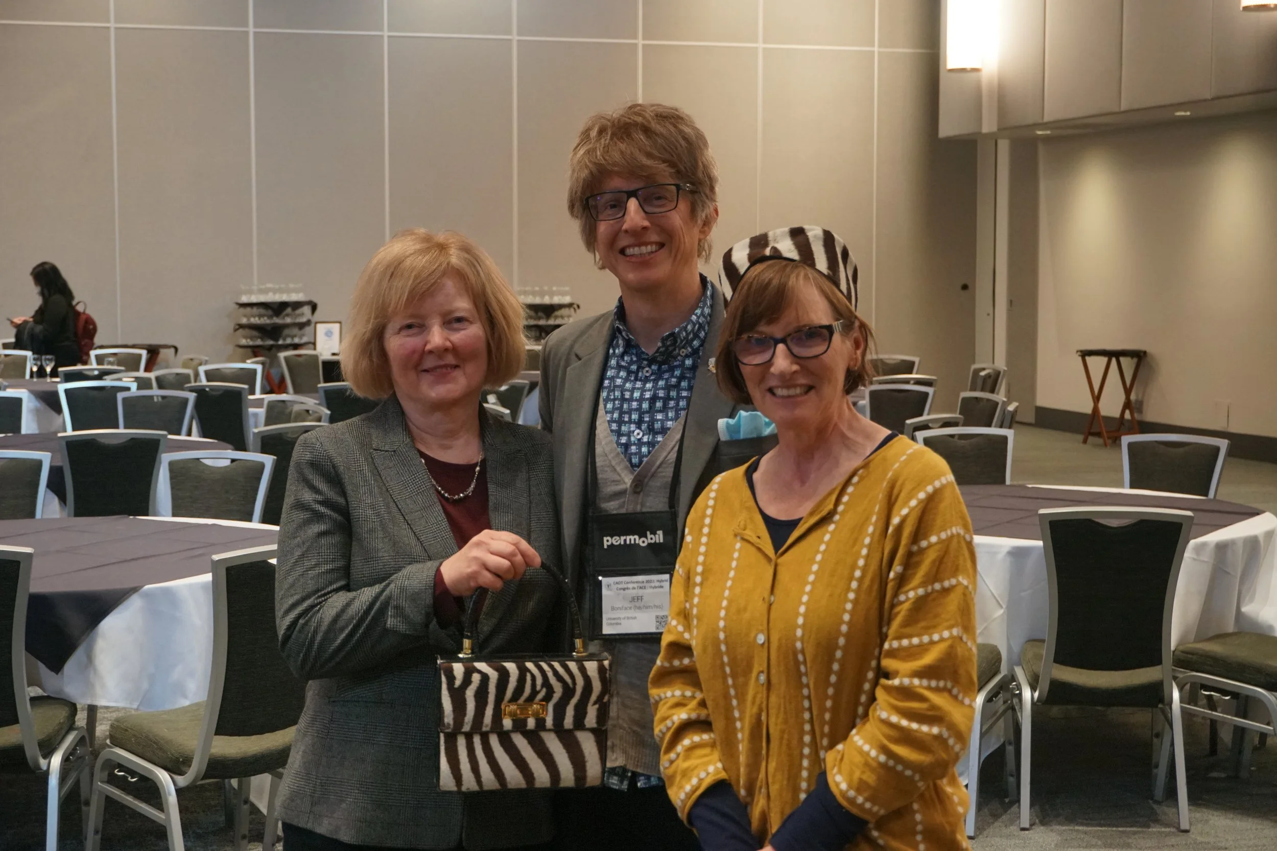 Gayle Restall, Jeff Boniface, and Mary Egan with the COTF Auction zebra hat and purse at the CAOT 2022 Conference in Whistler, BC.