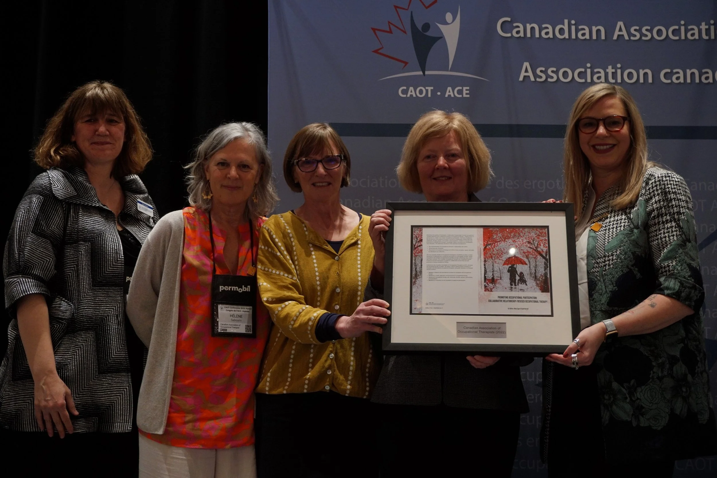Launch of the Promoting Occupational Participation textbook with its editors, CAOT Board President Giovanna Boniface, CAOT CEO Helene Sabouin and staff at the CAOT Conference, Whistler, British Columbia, 2022.