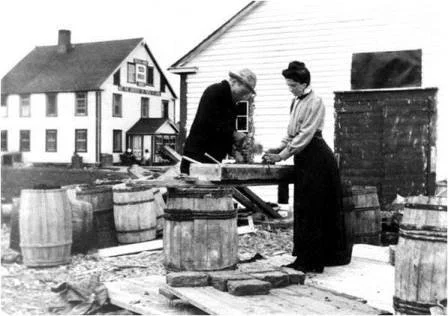 Jessie Luther supervising the building of a kiln for pottery making at the Grenfell Mission, St. Anthony, Nfld., 1908.
