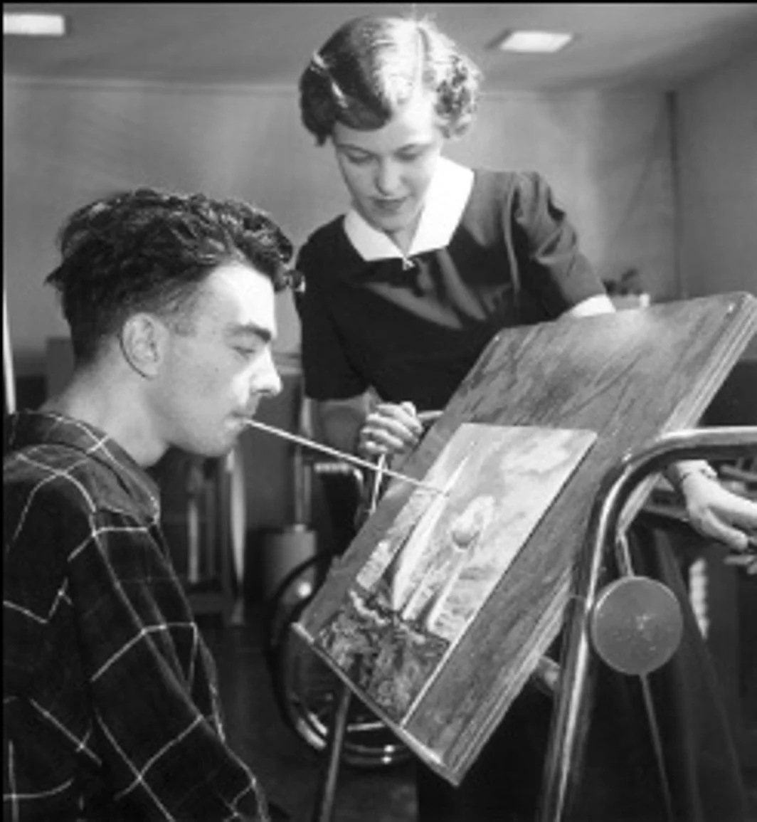 Occupational therapist enabling painting skills with an amputee patient 1940s. 