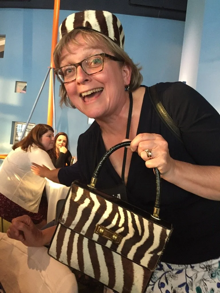McMaster U's Dr Lori Letts modeling the highly sought after COTF Auction item- the zebra purse and hat (donated by Sharon Brintnell) at the CAOT 2018 conference.